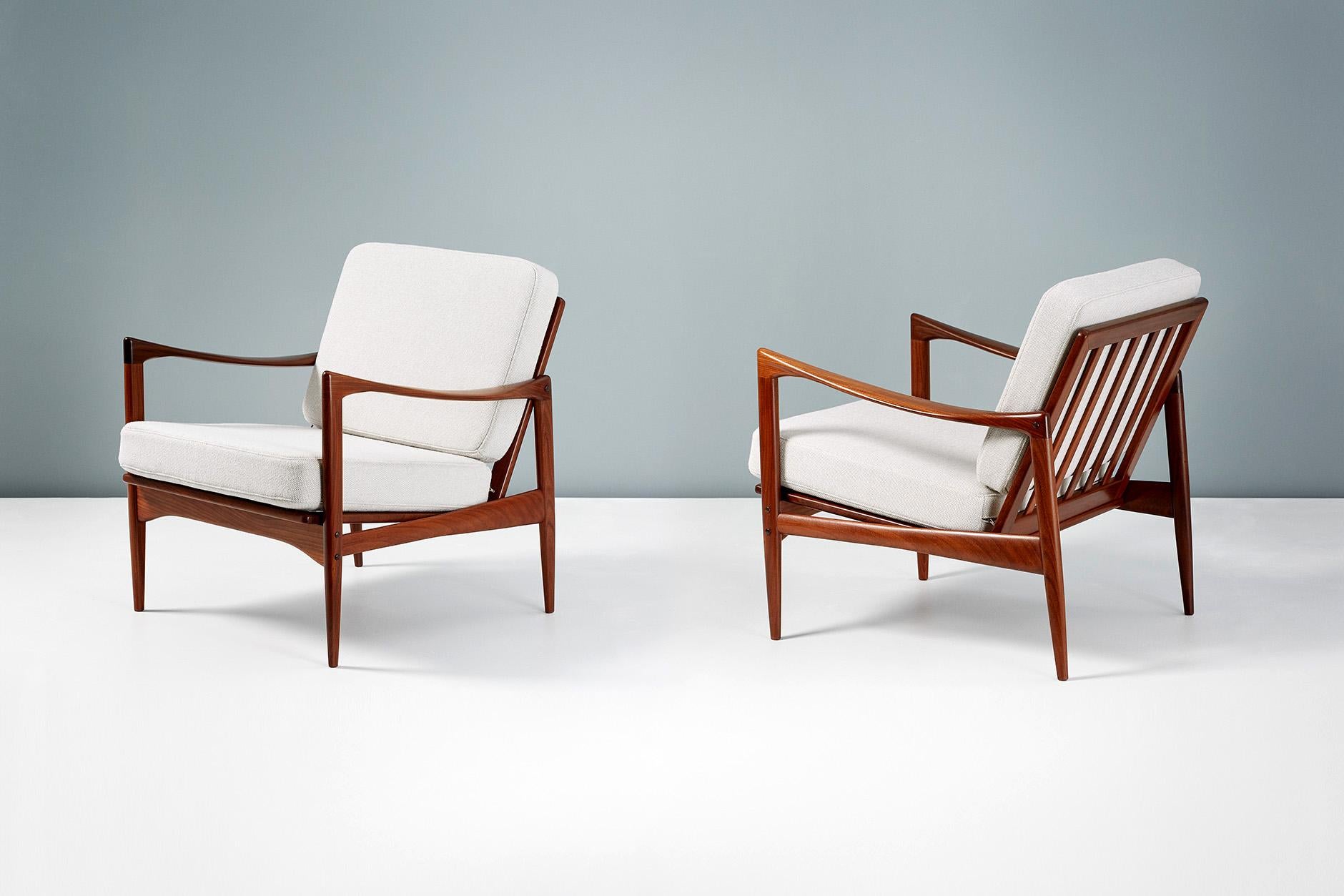 A pair of Afromosia African teak 'Kandidaten', (Candidate), lounge chairs produced by Olof Perssons Fatoljindustri (O.P.E.) in Jonkoping, Sweden circa 1960. 

Danish master Ib Kofod-Larsen gained popularity in his native Denmark in the 1950s via
