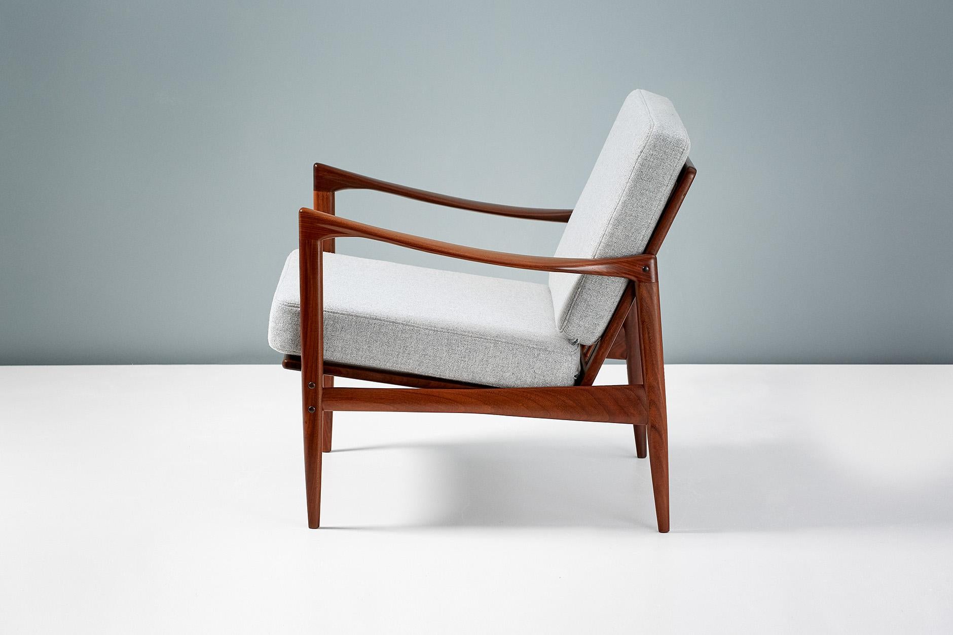 A pair of Afromosia African teak 'Kandidaten', (Candidate), lounge chairs produced by Olof Perssons Fatoljindustri (O.P.E.) in Jonkoping, Sweden, circa 1960. 

Danish master Ib Kofod-Larsen gained popularity in his native Denmark in the 1950s via