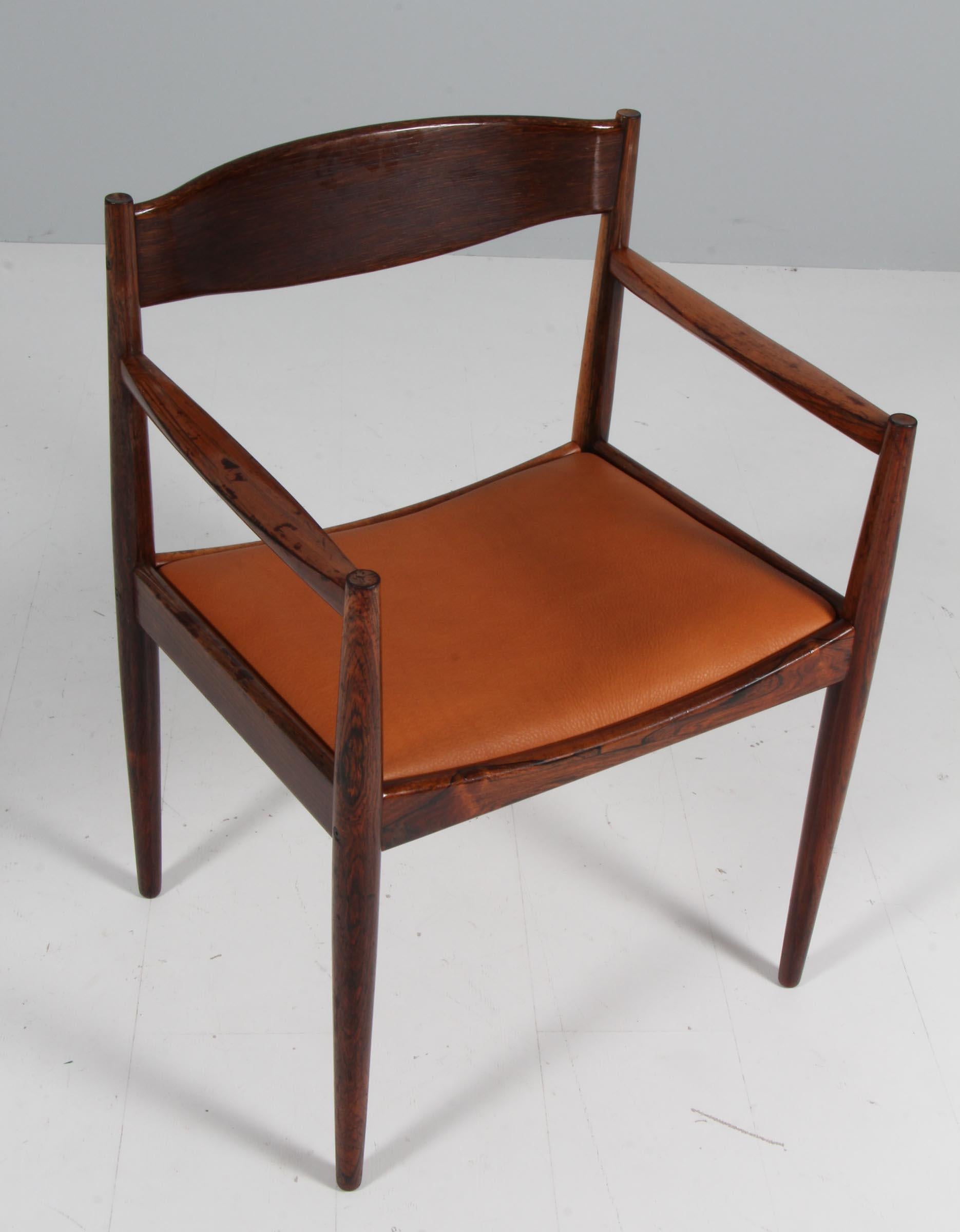 Ib Kofod-Larsen armchair in partly solid rosewood.

New upholstered with tan vintage aniline leather.
 