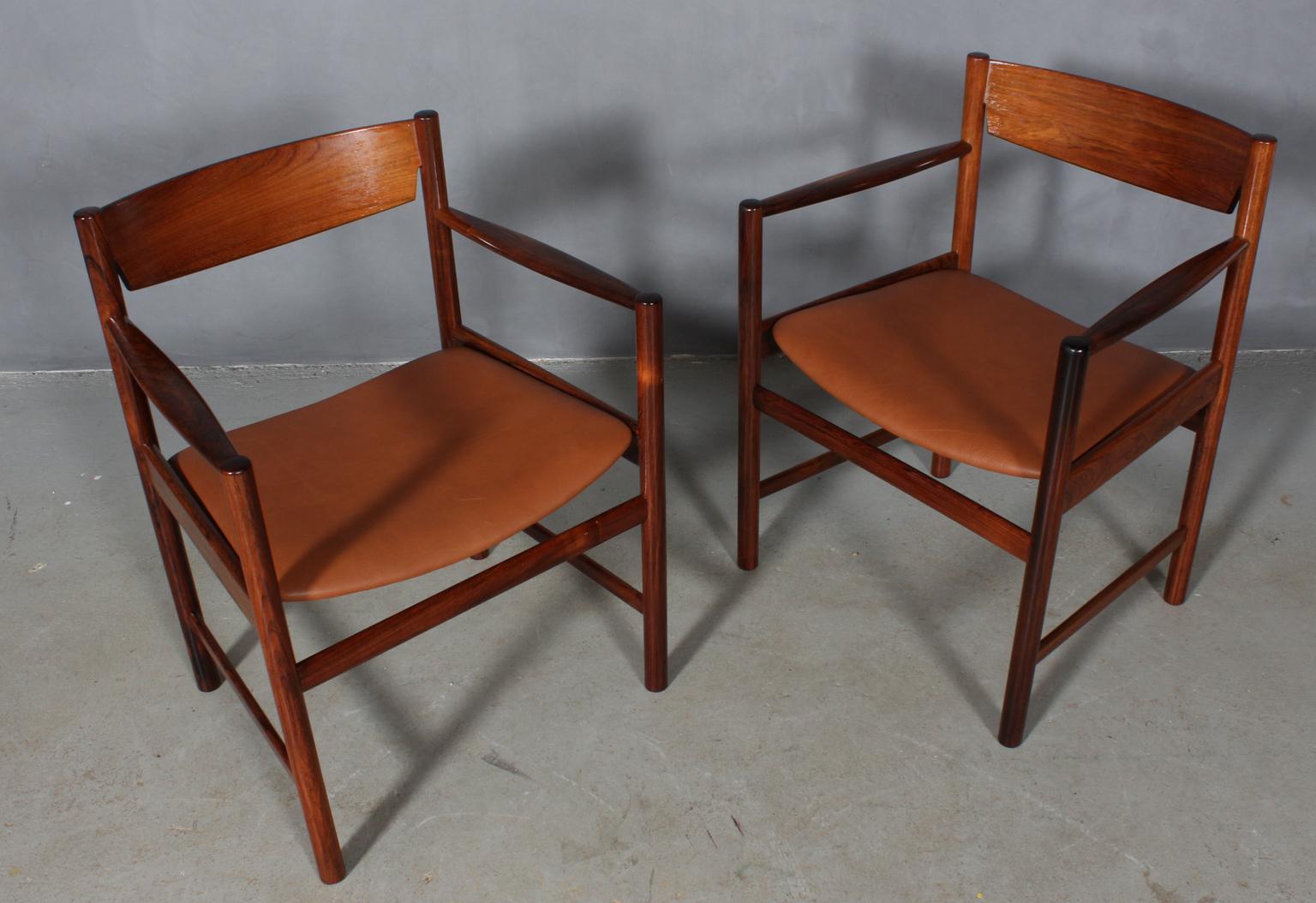 Ib Kofod-Larsen armchairs in partly solid rosewood.

New upholstered with tan vintage aniline leather.
      