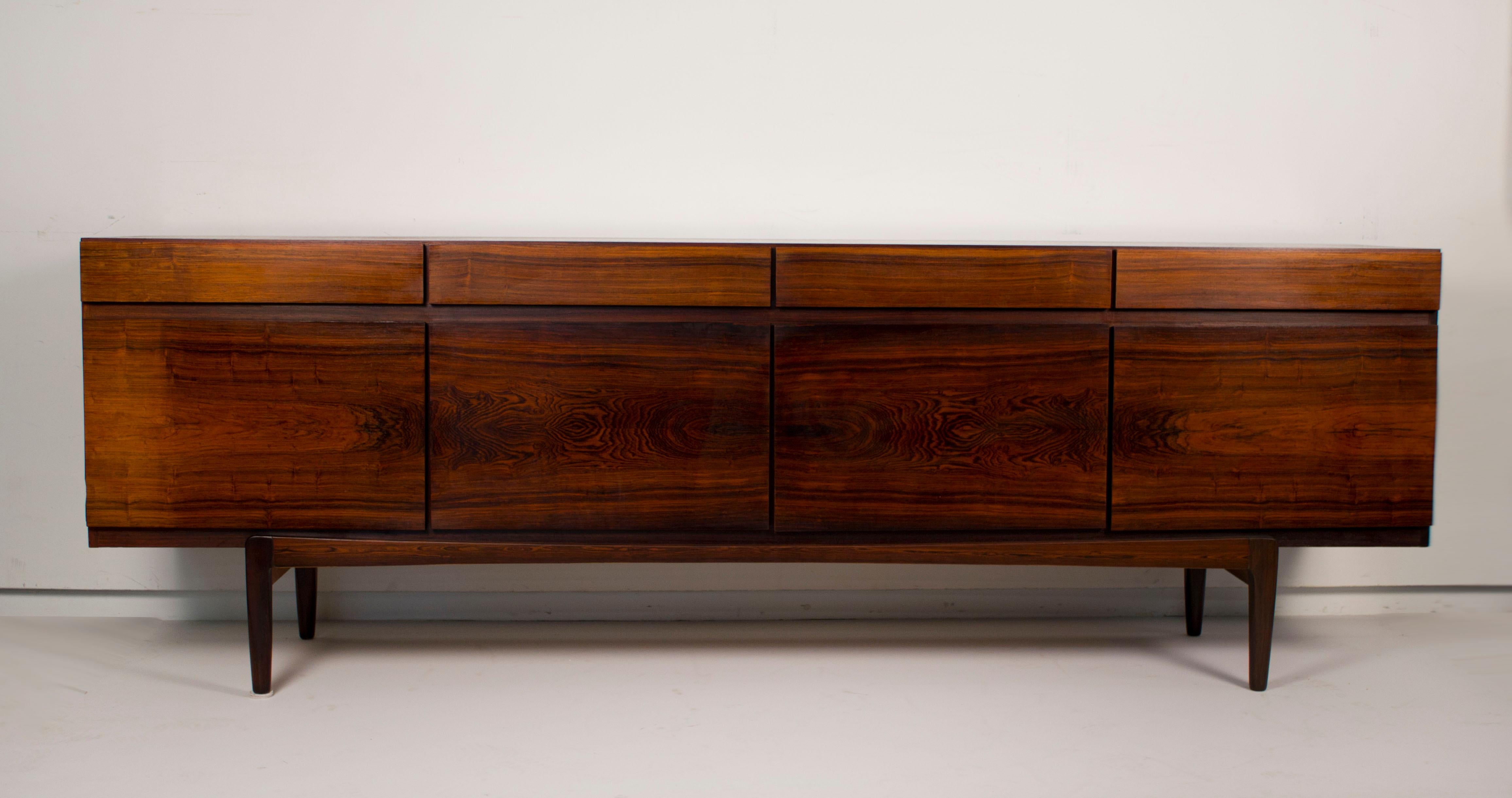 Extraordinary Brazilian rosewood cabinet designed by Ib Kofod-Larsen for Faarup Møbelfabrik. Model no. FA 66. This Scandinavian masterpiece is in very good original condition. Very exotic striations in the grain.

Cabinet features four drawers