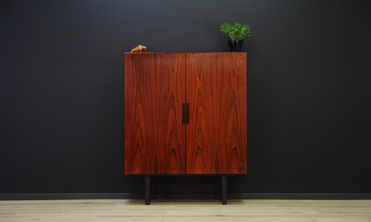Retro cabinet from the 1960s-1970s, minimalistic Danish design. The work of designer Ib Kofod-Larsen. Manufactured in Faarup Møbelfabrik. Surface veneered with rosewood. A lot of space and two adjustable shelves behind the doors. Preserved in good