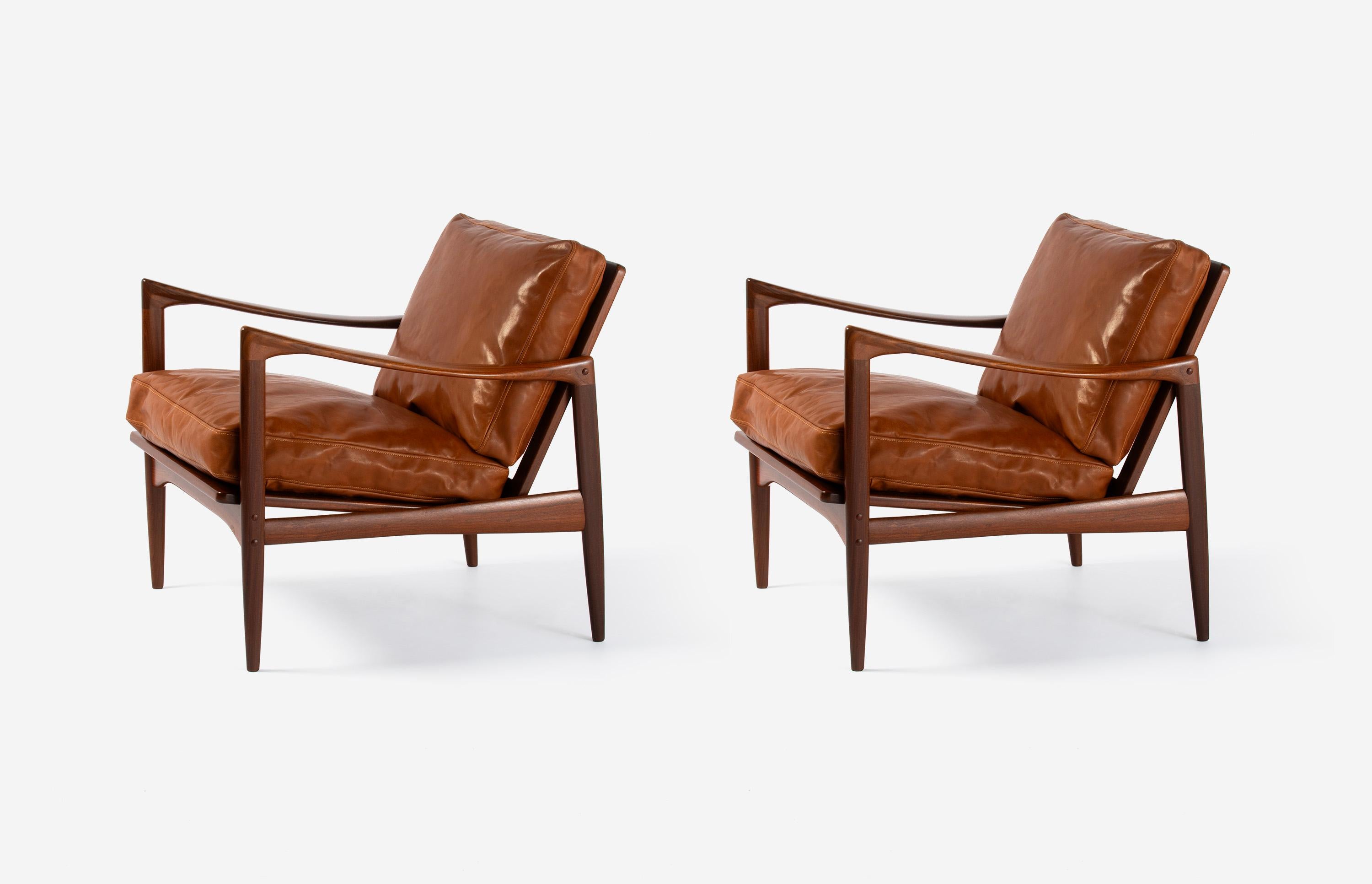 A pair of Afromosia African teak 'Kandidaten', (Candidate), lounge chairs produced by Olof Perssons Fatoljindustri (O.P.E.) in Jonkoping, Sweden, circa 1960. 

Danish master Ib Kofod-Larsen gained popularity in his native Denmark in the 1950s via