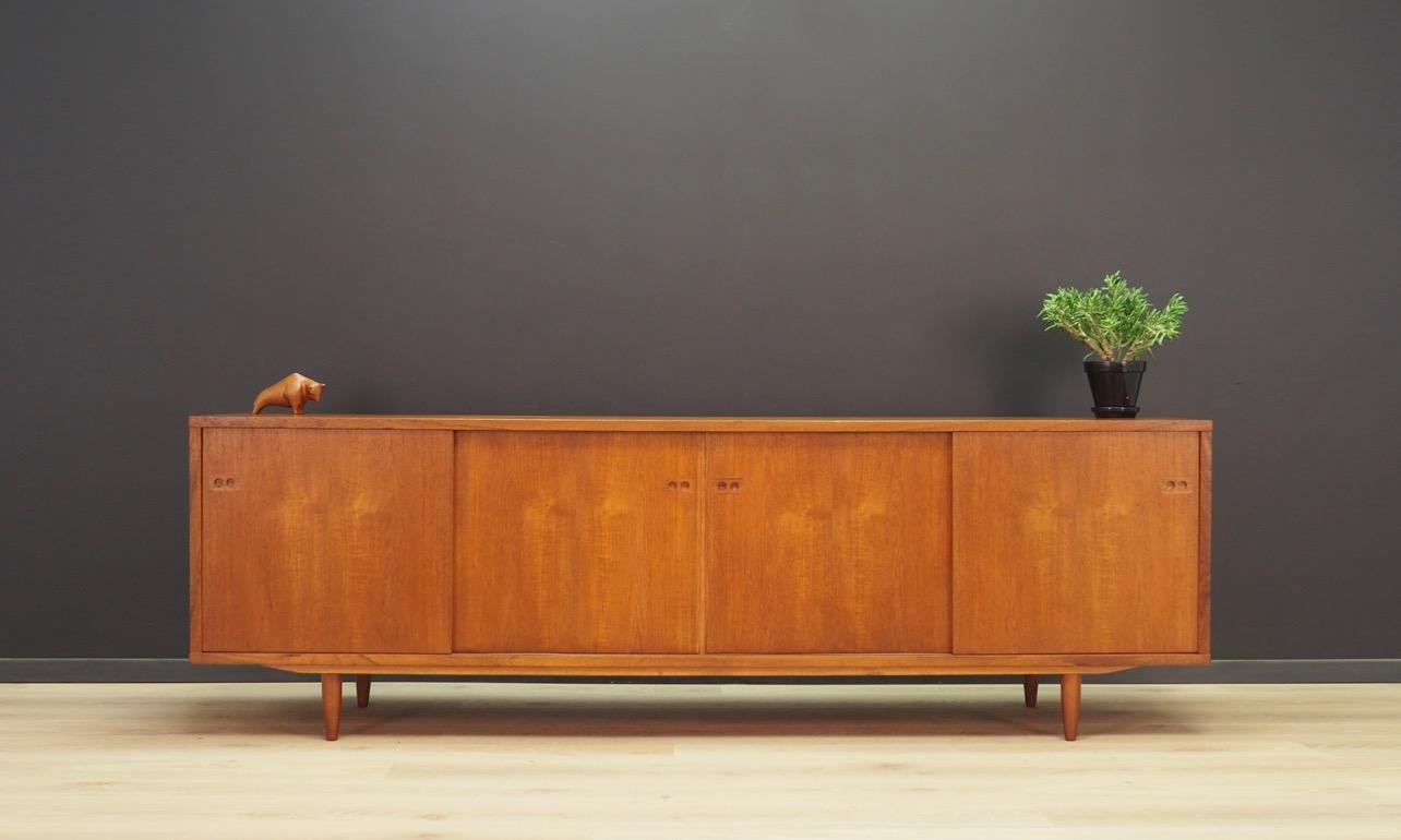 Fantastic sideboard, Danish minimalism from the 1960s-1970s, designed by Ib-Kofod Larsen. Amazing form with a spacious interior with shelves and drawers behind sliding doors. Sideboard veneered with teak. Preserved in good condition (small bruises