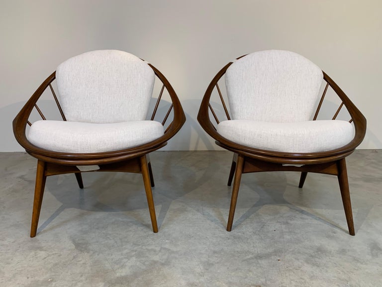 IB Kofod Larsen hoop chairs having beech wood frames with fresh, soft upholstery and new fagas straps underneath. The cushions firmly attach via Velcro underneath and buttons on the backrest. Very sturdy and extremely comfortable with no slippage.