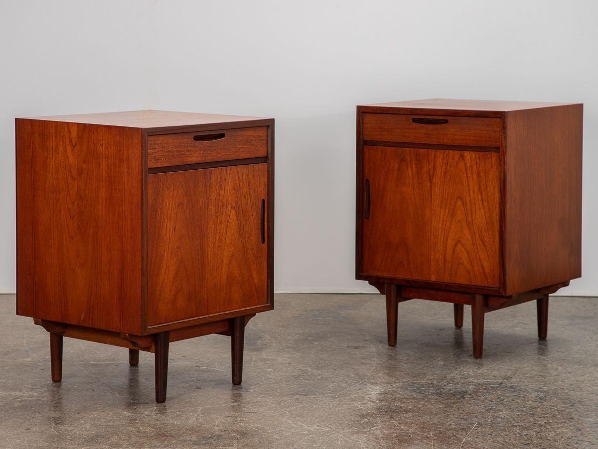Handsome Danish Modern end tables, designed by Ib Kofod-Larsen for Brande Møbelfabrik. Minimal, boxy silhouette, featuring drawers and interior shelving for storage. Gorgeous teak wood has been recently polished and shows nice patina. A practical