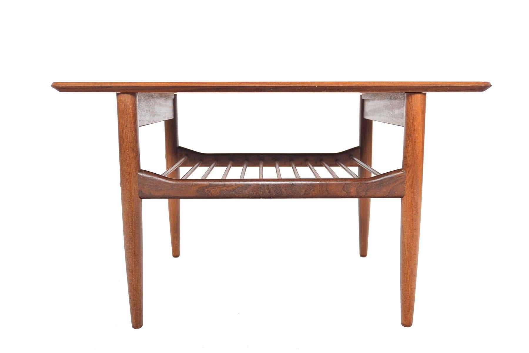 Designed by Ib Kofod-Larsen for G Plan’s Danish range in the 1960s, perfectly detailed side table is crafted in old- growth teak. A lower doweled rack provides storage. In excellent original condition.

 