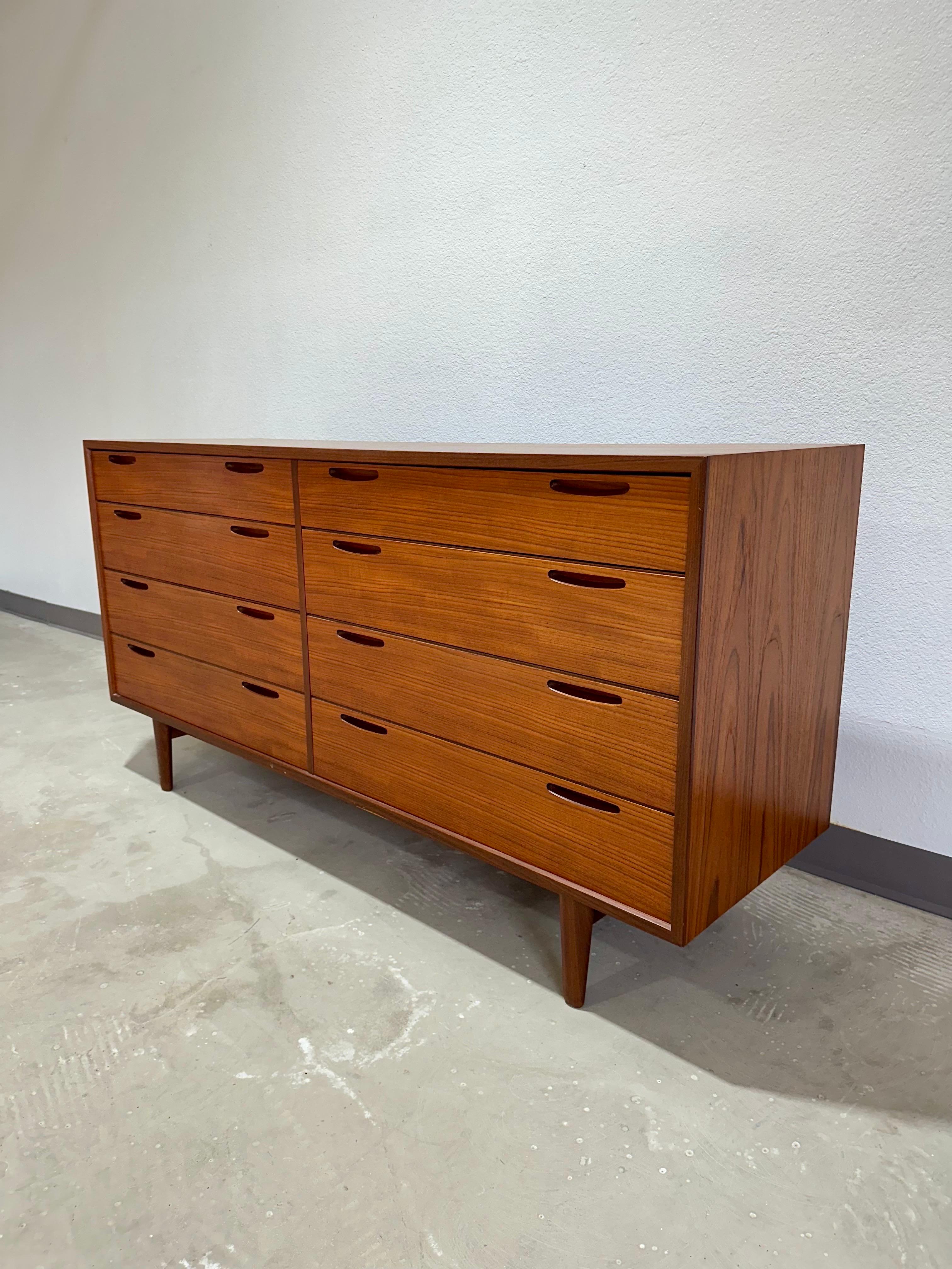 Danish Mid Century Modern Teak 8 drawer dresser designed by Ib Kofod-Larsen for J. Clausen & Son Brande Mobelfabrik c.1960’s. Beautiful piece with inset teak pulls and dovetail joints. Good vintage condition, minimal signs of use, chip at edge of