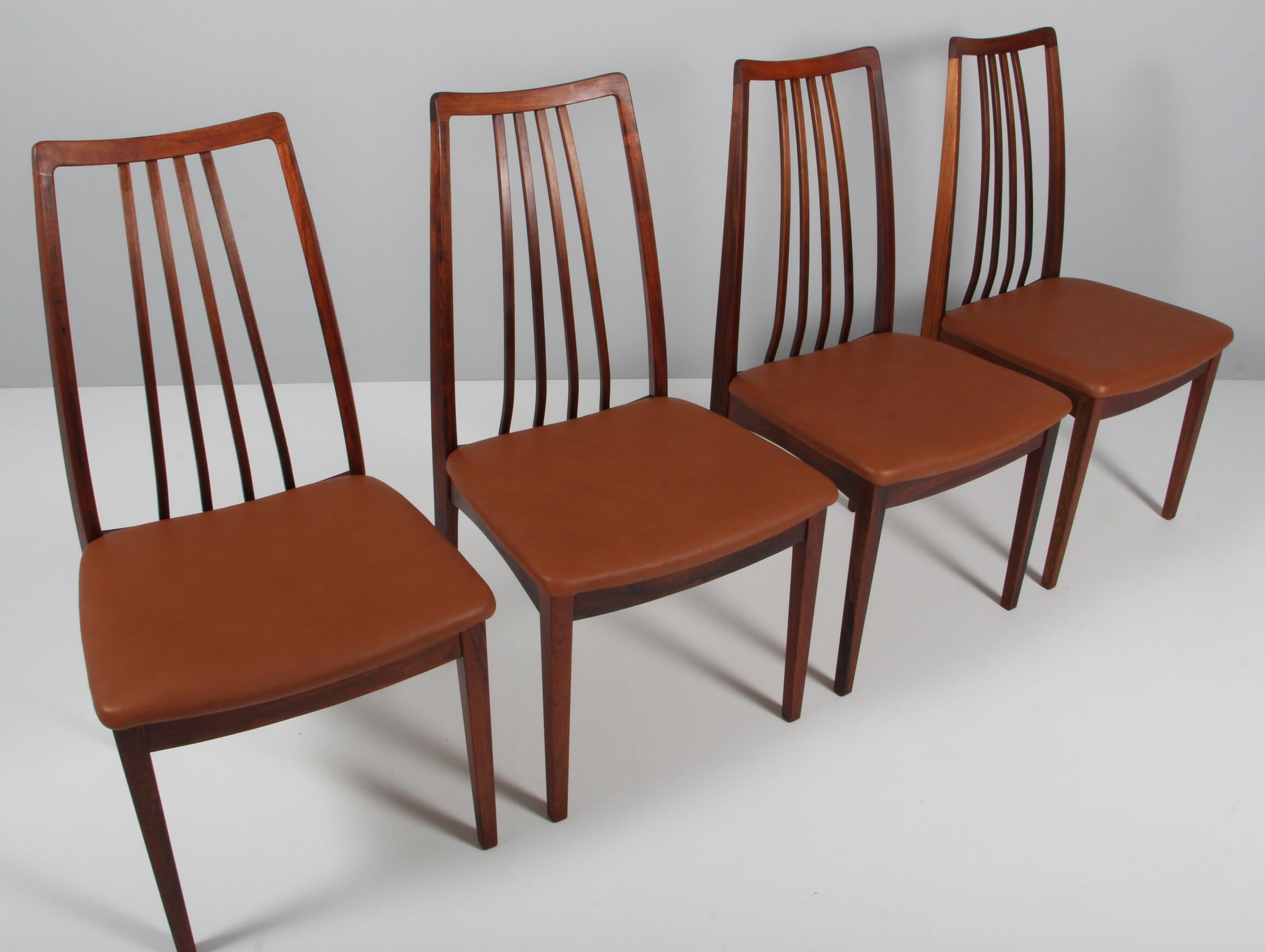 Ib Kofod-Larsen dining chairs in partly solid rosewood.

New upholstered with tan vintage aniline leather.
  
Made by Uldum Møbelfabrik.