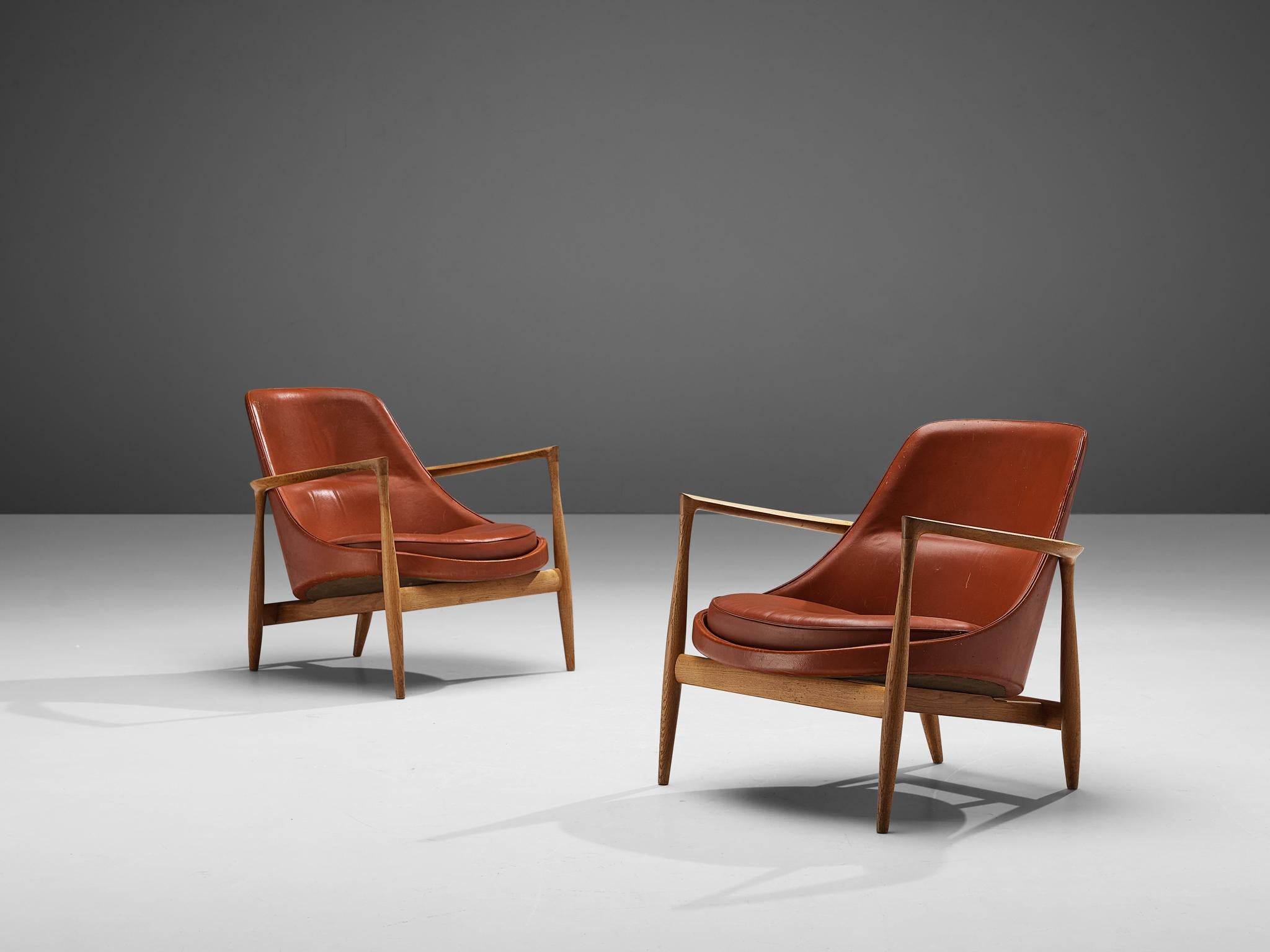 Ib Kofod-Larsen, Sessel Modell U-56 'Elizabeth', Eiche, rotes Leder, Dänemark, Entwurf 1956

Ein Paar Sessel, entworfen von Ib Kofod-Larsen im Jahr 1956. Diese Stühle von Kofod-Larsen sind von höchster Qualität, mit einem Gestell aus Eichenholz und