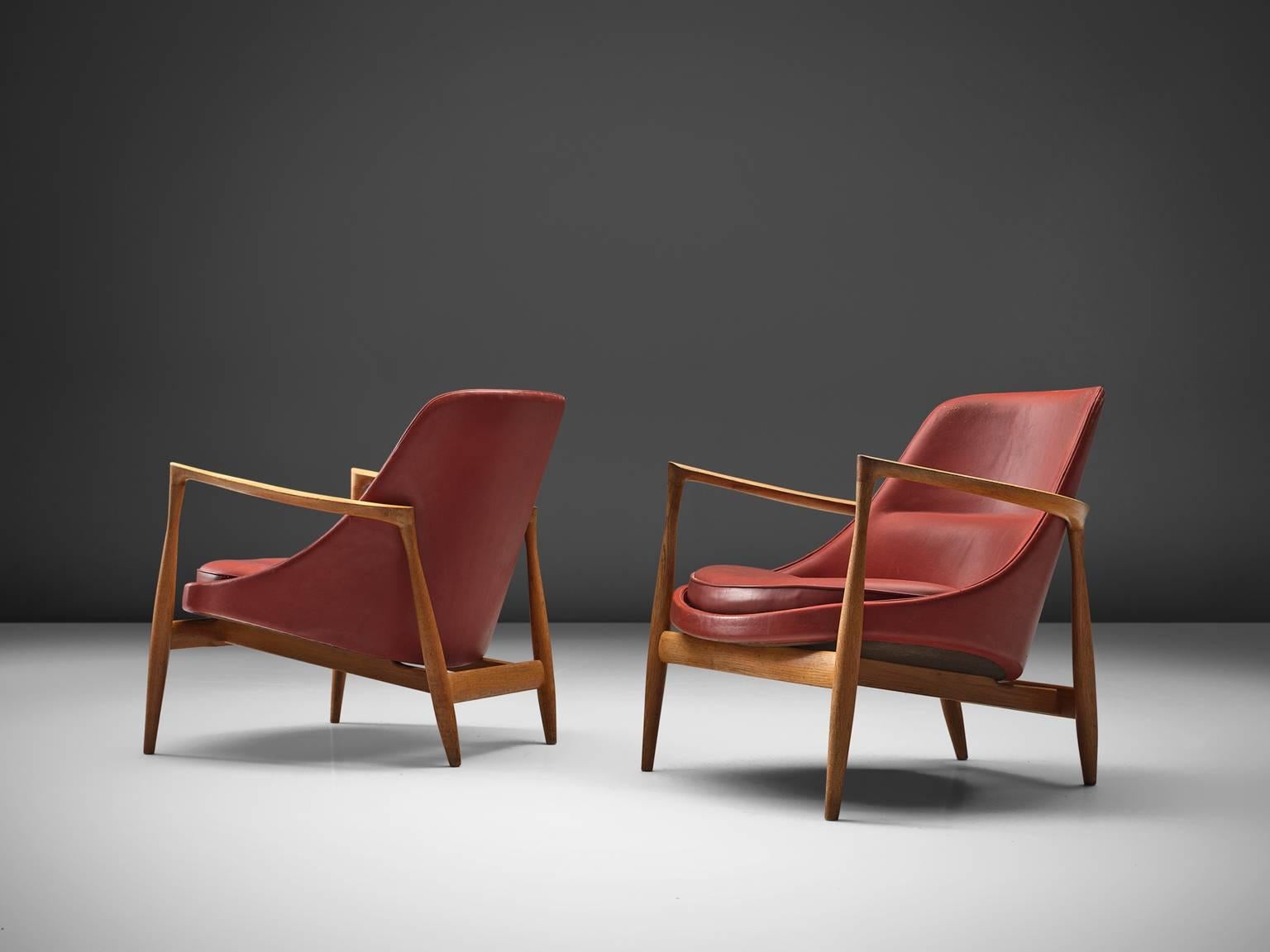 Ib Kofod-Larsen, two lounge chairs, model U-56 'Elizabeth', oak and red leather, Denmark, 1956. 

These are two of Kofod-Larsen highest-quality armchairs, with an oak frame and beautiful details in the design. The leather holds the original leather.