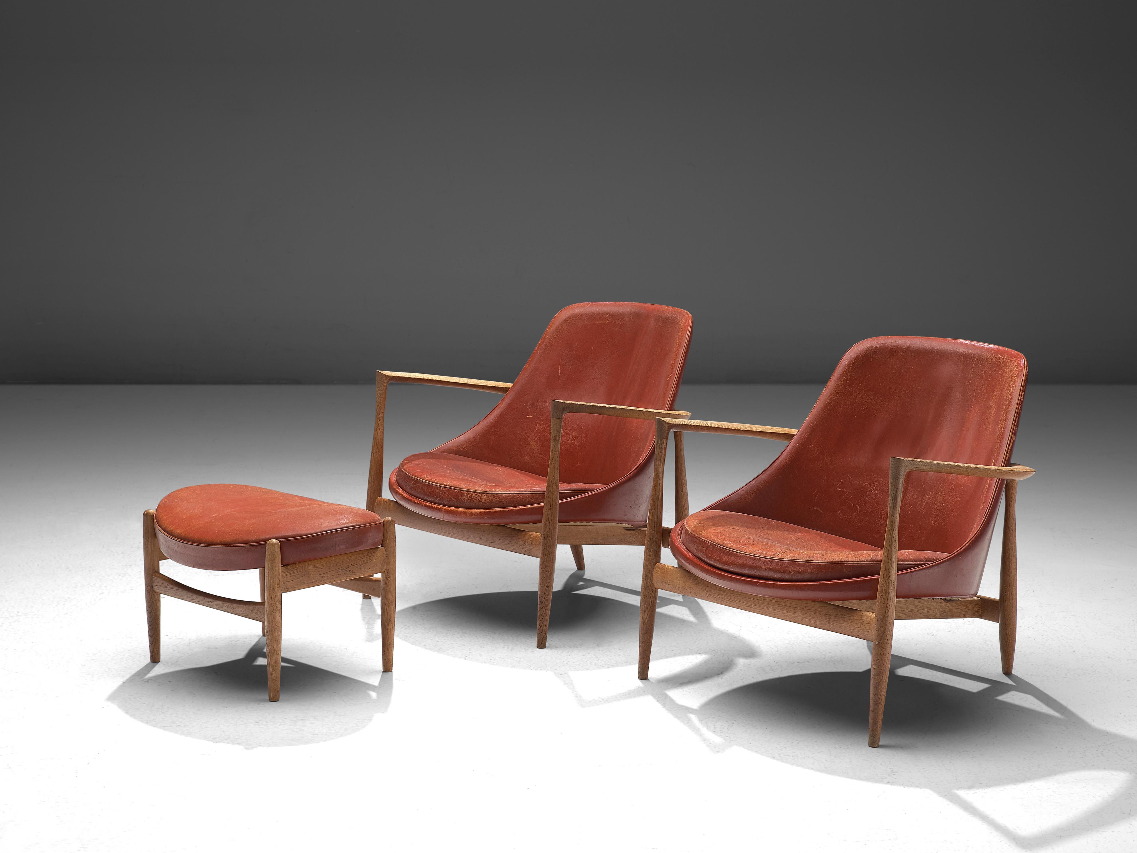 Ib Kofod-Larsen, two lounge chairs with ottoman, model U-56 'Elizabeth', oak and red leather, Denmark, 1956.

These are two of Kofod-Larsen highest-quality armchairs, with an oak frame and beautiful details in the design. The seating holds beautiful