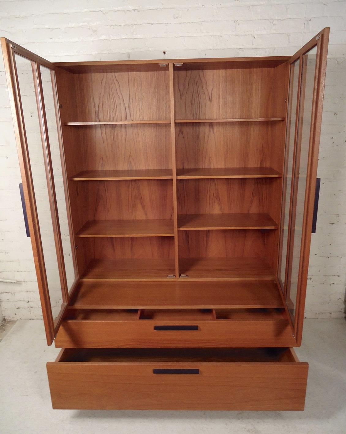 Large two-piece wall unit with bottom wide drawer storage and bookcase topper with glass doors.
(Please confirm item location - NY or NJ - with dealer).
          