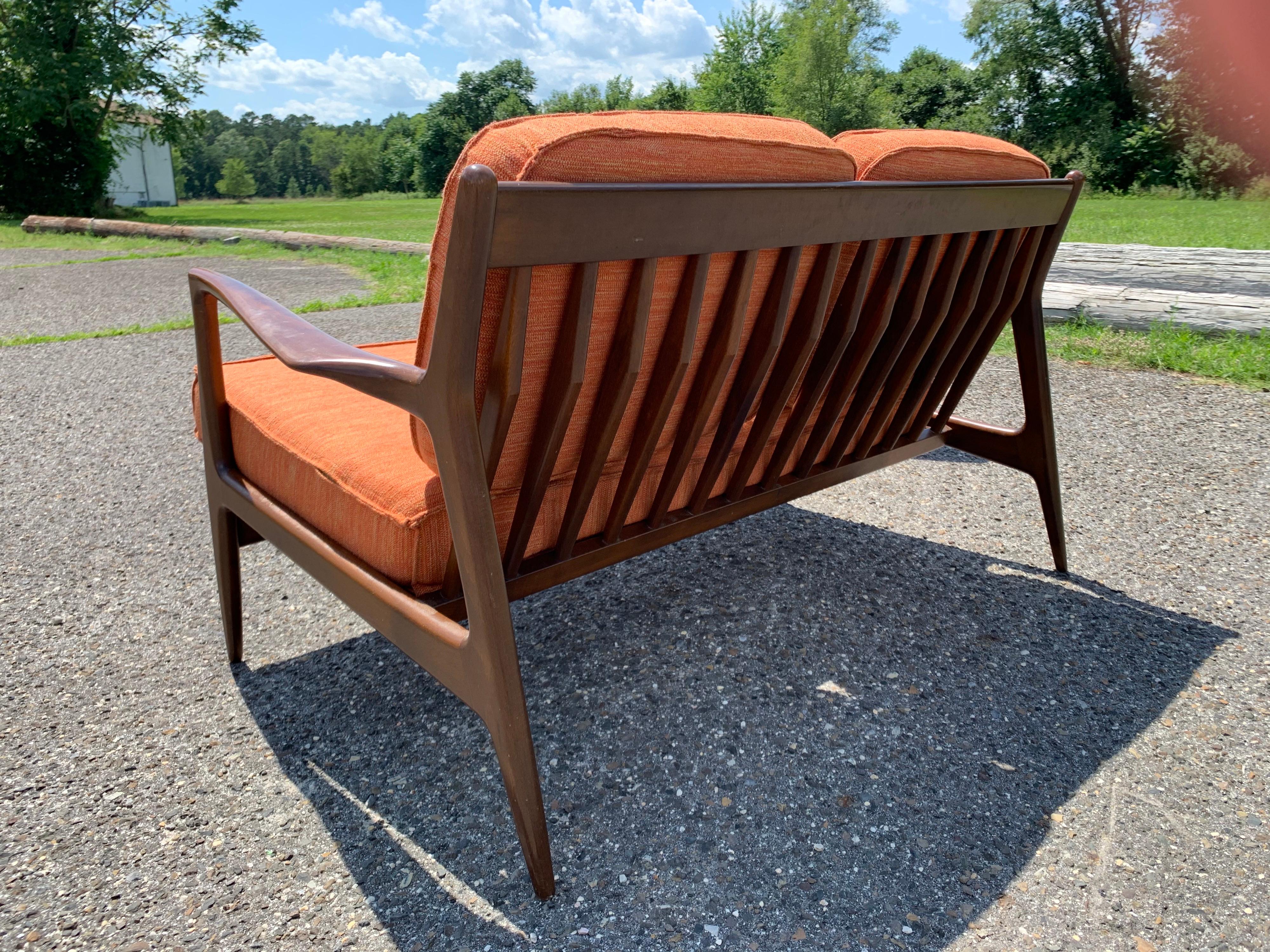 A beautiful 2 piece sectional sofa designed by IB Kofod Larsen and imported by SELIG-Denmark. 
Bench frames with new straps. Upholstery is recommended and wood has some light usage scratches which can easily be refinished. 
NOTE! I have since