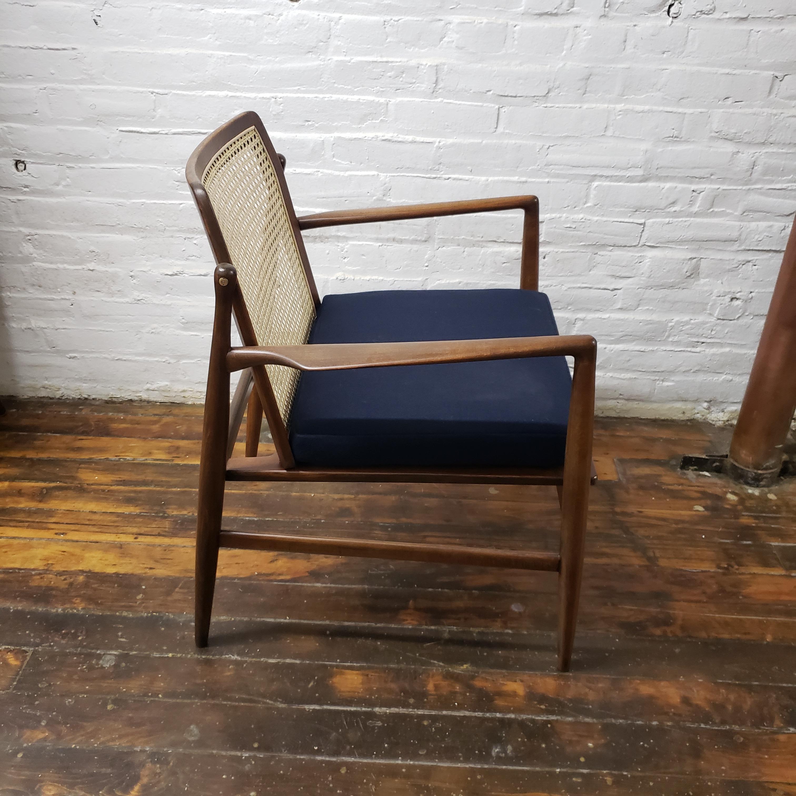 Ib Kofod-Larsen for Selig cane back side chair.

Beautiful refinished walnut and cane back chair by Ib Kofod-Larsen for Selig with new cane and navy Maharam wool upholstery.
 

 