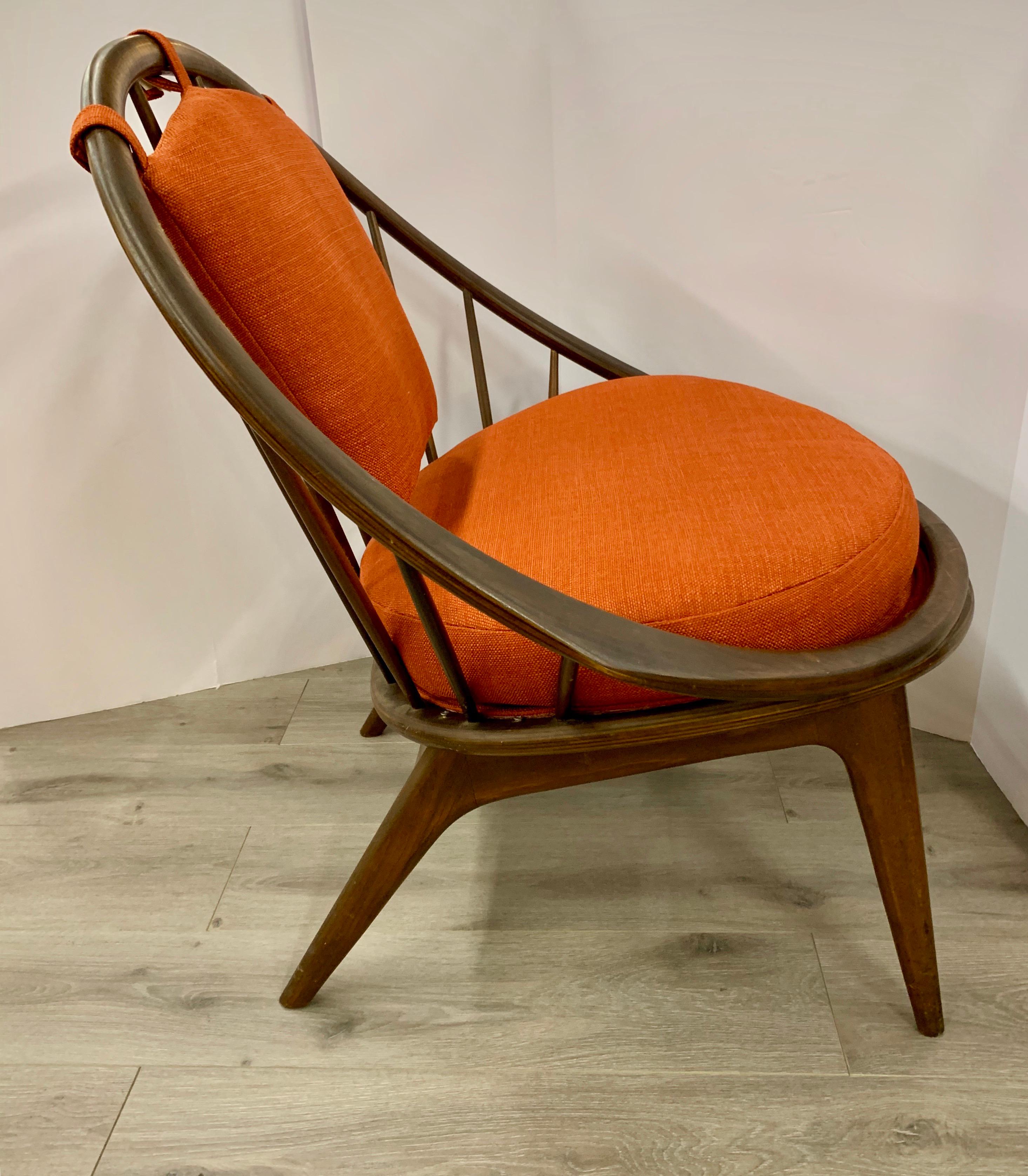 Midcentury hoop chair by Ib Kofod-Larsen for Selig is highly collectible with a spindle back design and gorgeous contours. Newly upholstered in an orange linen fabric.