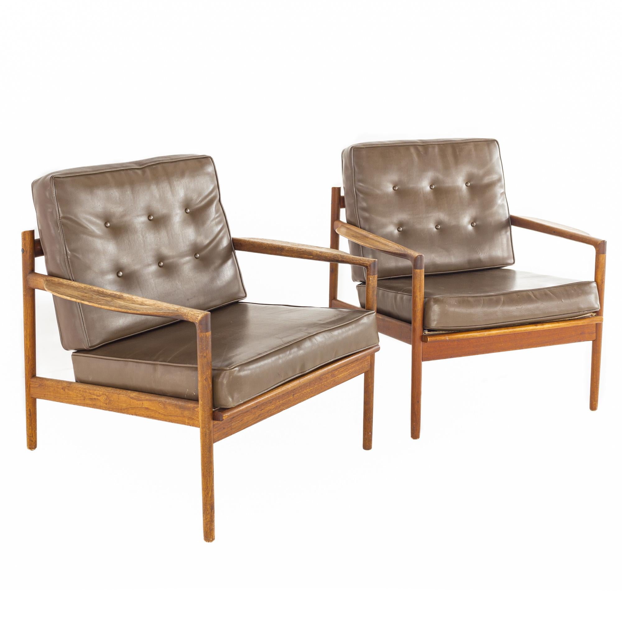 Ib Kofod Larsen for Selig mid-century walnut lounge chairs - a pair.

Each chair measures: 29.75 wide x 29 deep x 28.5 high, with a seat height of 16 and arm height of 21 inches.

All pieces of furniture can be had in what we call restored