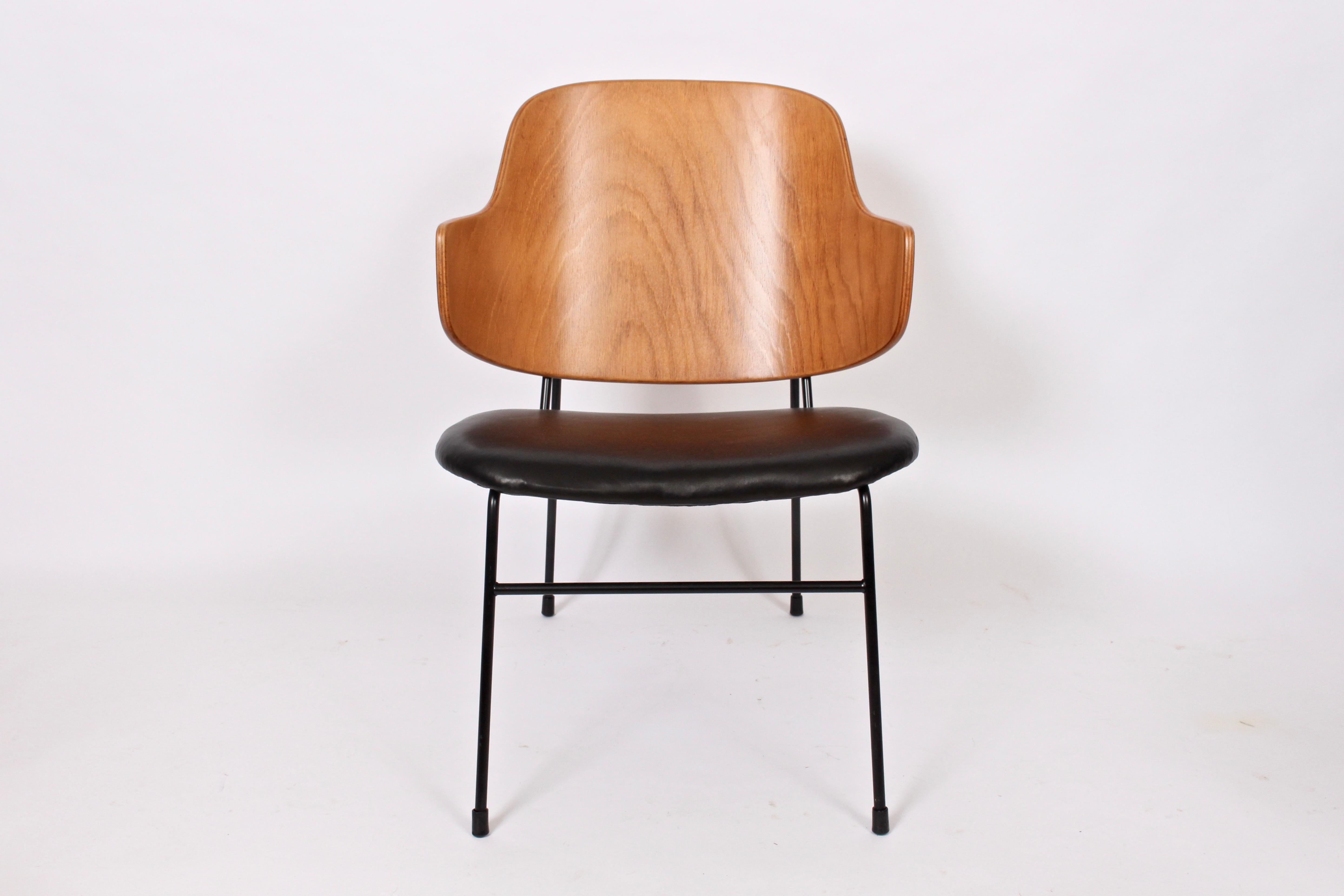 Classic Danish modern Kofod-Larsen penguin chair. Featuring a sturdy black wrought Iron framework with capped feet, slightly slanted and newly upholstered black leather seat with comfortable angled bentwood seat back. (Seat height 13