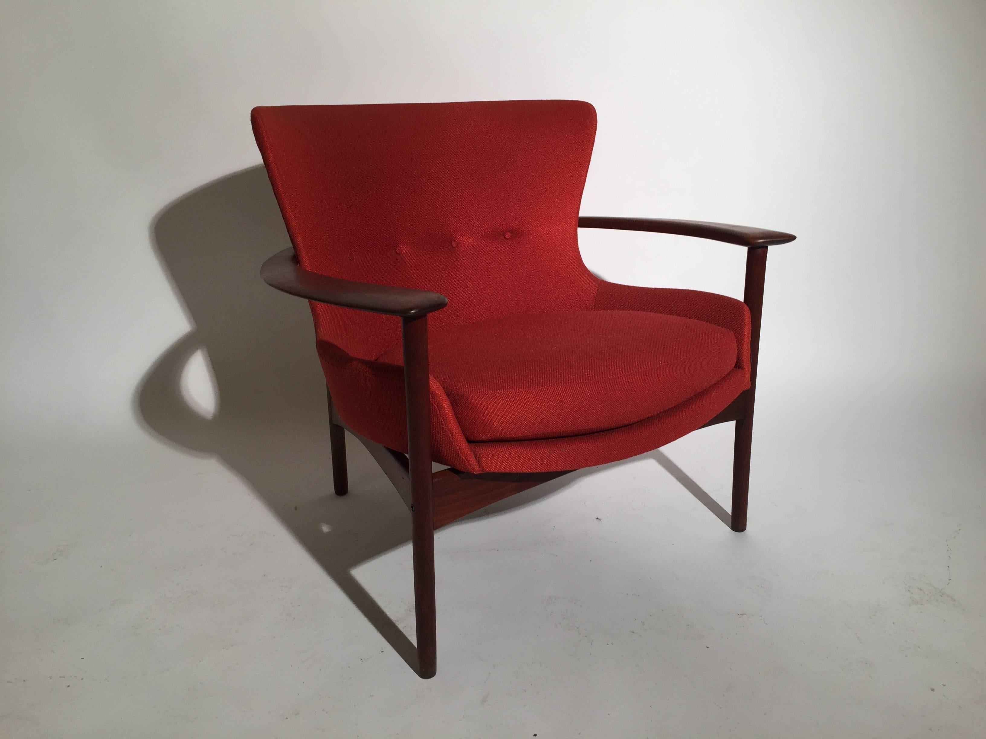 High style and dramatic Larsen for Selig teak lounge chair, circa 1950s. Original rust or burnt orange upholstery in near-perfect condition, and teak frame with warm brown patina with a few dings as can be expected of a 60 year old chair. Selig