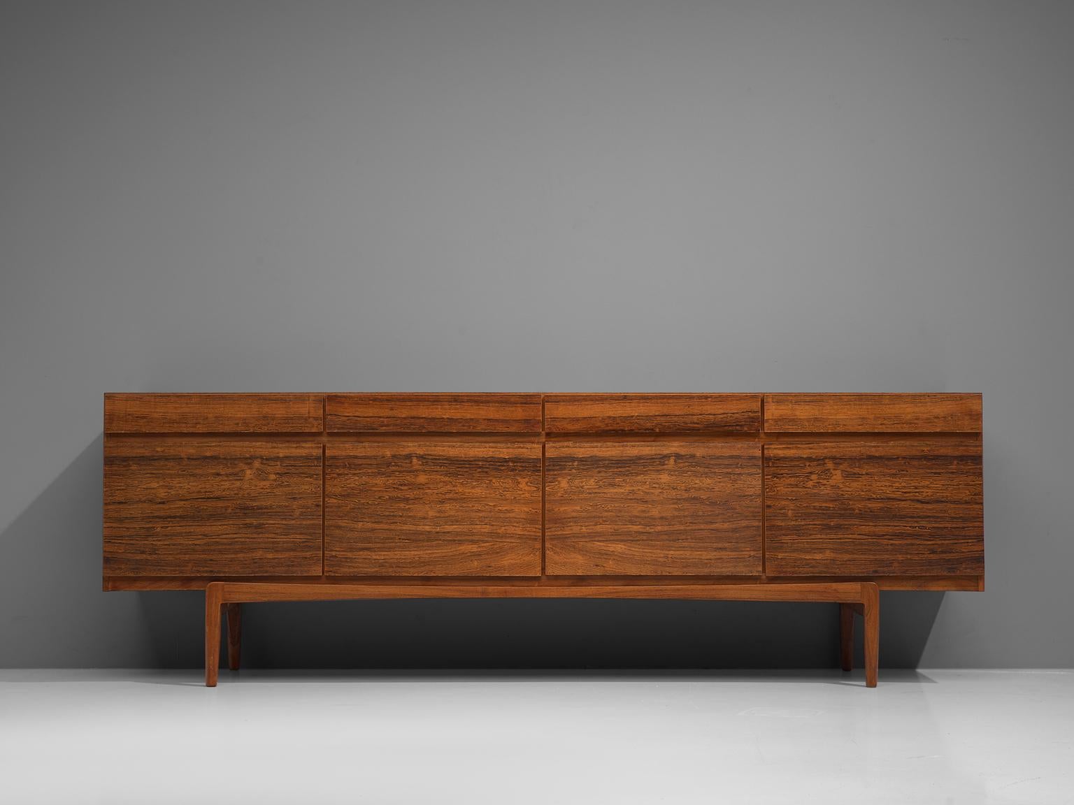 Ib Kofod-Larsen for Faarup Møbelfabrik, sideboard model FA66, rosewood, Denmark, 1960s.

Excellent designed credenza by Ib Kofod-Larsen. The sideboard contains four doors with four drawers directly above it. The inside contains three shelves and