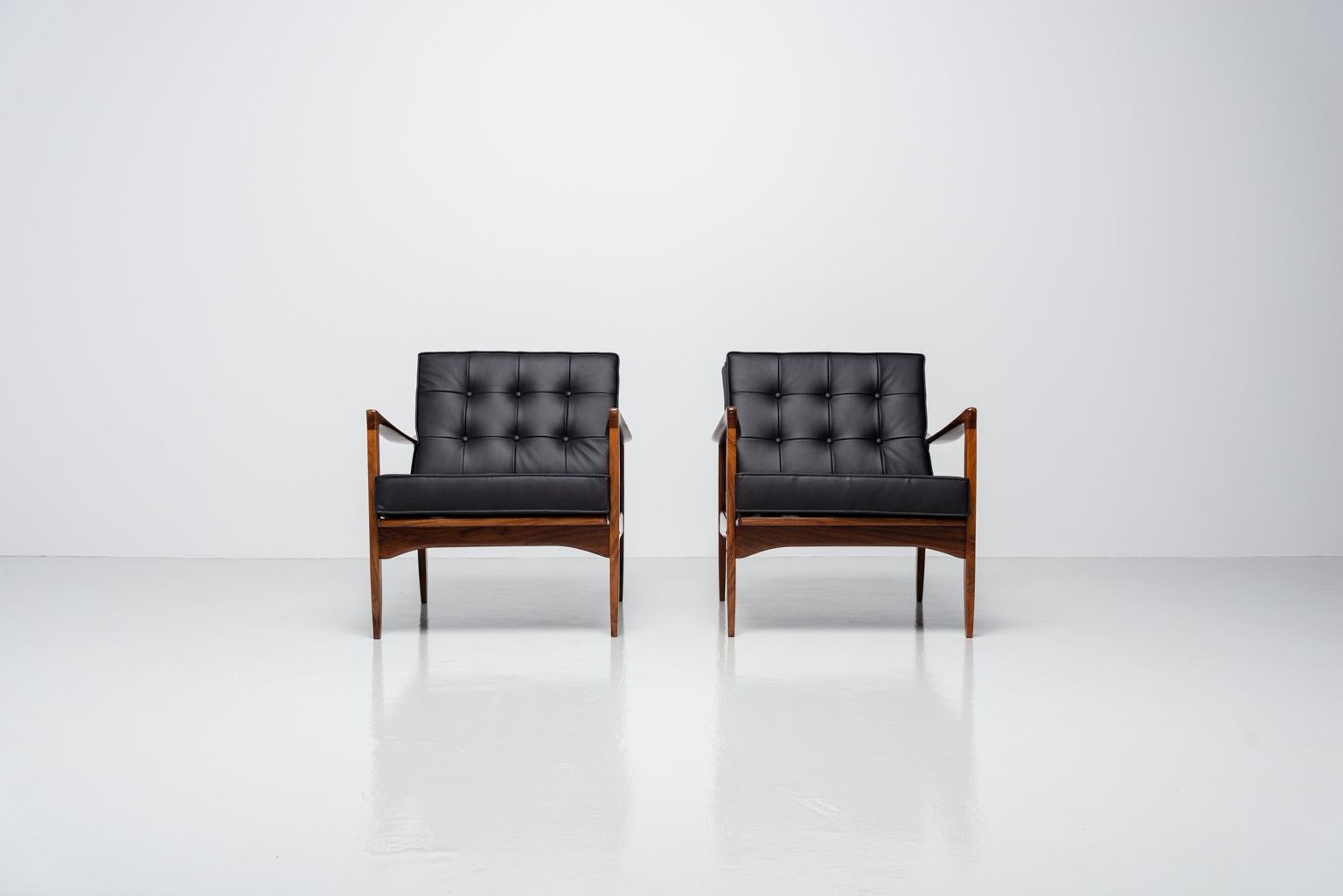 Stunning pair of so called 'Kandidaten' (candidate) lounge chairs designed by Ib Kofod Larsen and manufactured by OPE, Sweden 1958. The chairs have a sculptural solid rosewood frame and are newly upholstered like the original cushions in a premium