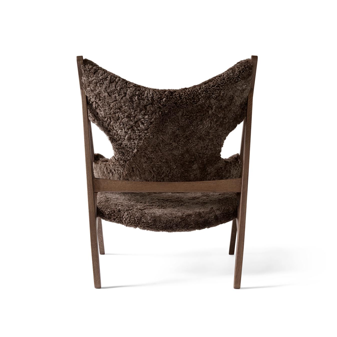 Defined by an exposed, triangular construction, a gently curved seat and back ideally pitched for relaxation, and distinctive cut-outs for resting the elbows when reading (or, of course, knitting), the Knitting Chair affirmed Kofod-Larsen’s