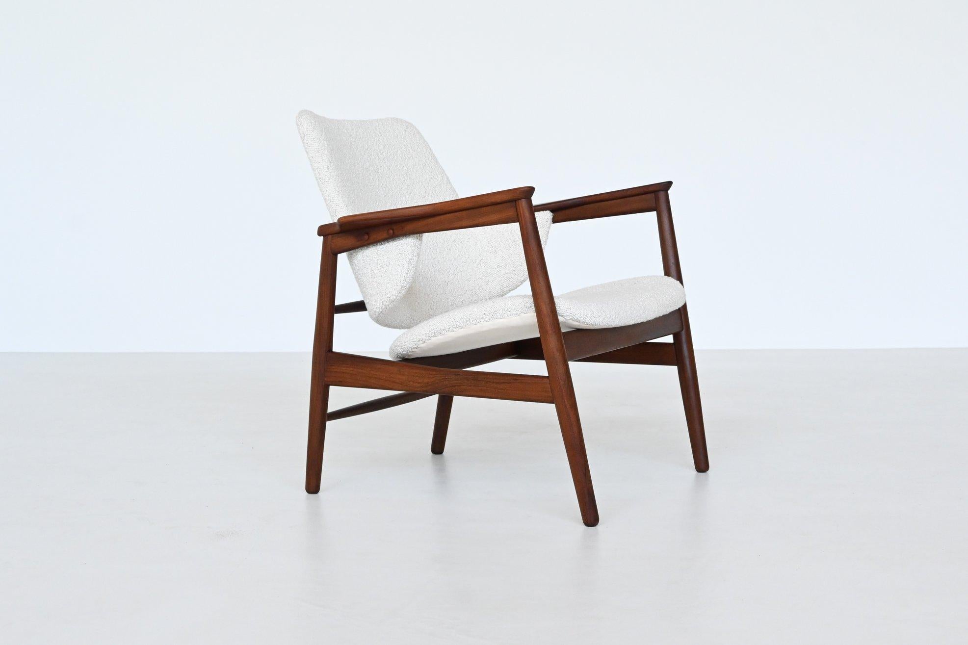 Stunning lounge chair designed by IB Kofod Larsen for Christensen & Larsen, Denmark 1953. This beautiful shaped and well-crafted chair has a solid teak wood frame and is newly upholstered with white bouclé fabric from Dedar Milano. The armrests
