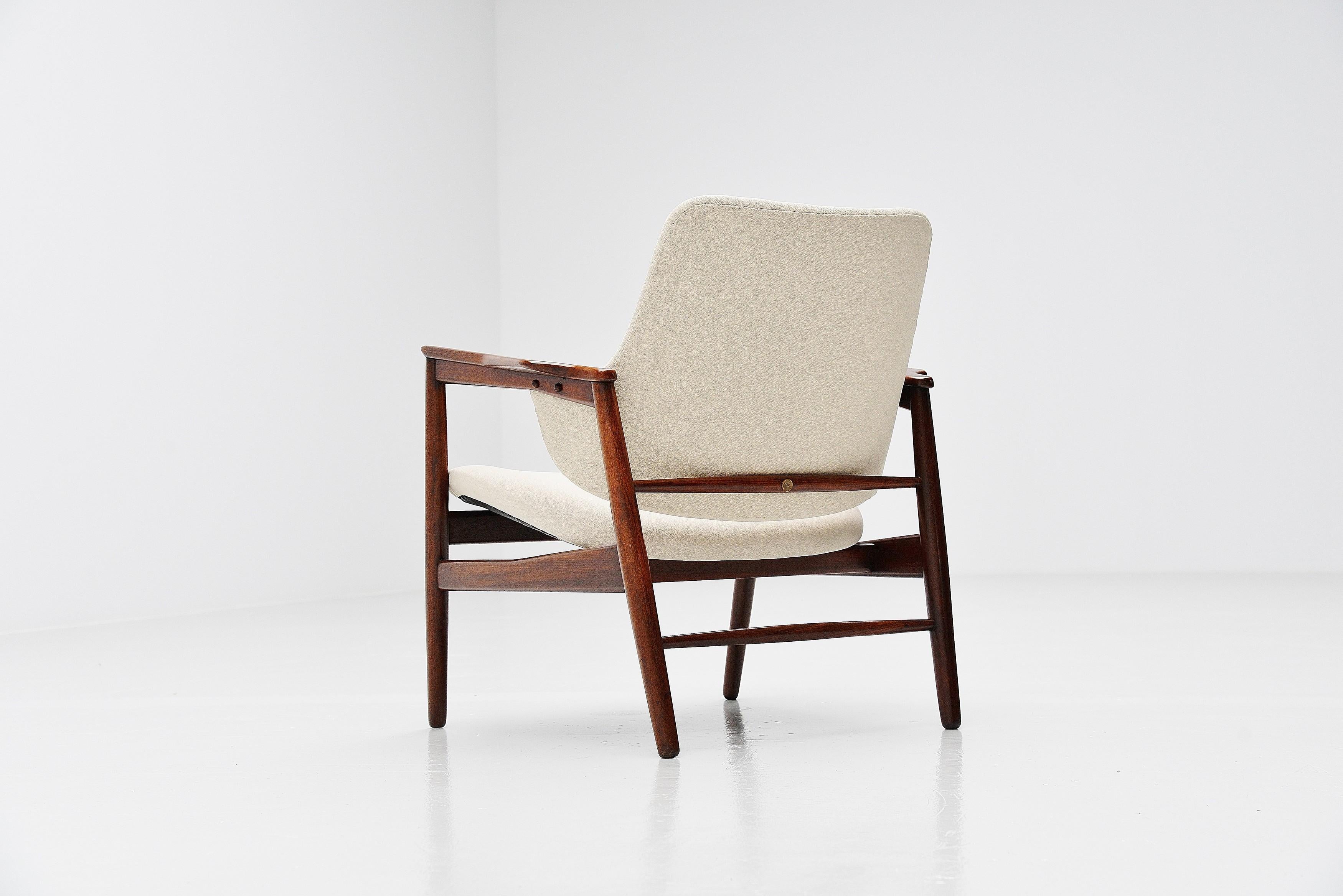 Super rare and beautiful easy chair designed by Ib Kofod-Larsen and manufactured by Christensen & Larsen Cabinetmakers, Denmark, 1953. This chair has a solid teak frame and is newly upholstered with beige fabric from Gabriel. The chair is a real