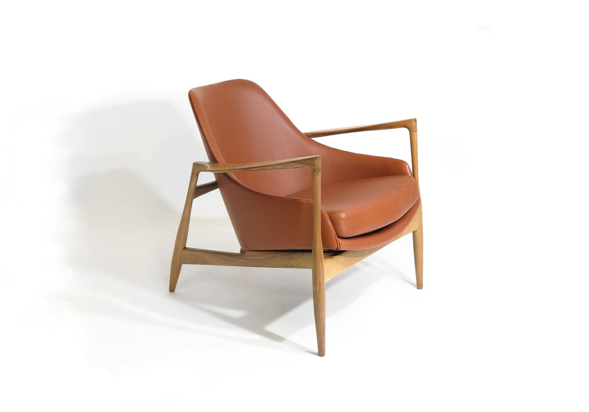 Rare Danish lounge chair designed by IB Kofod Larsen for G. Laauser, 1955. Finely sculpted frame of nut wood with a steamed back structure, and inner spring seat, covered in new aniline saddle leather. Finely restored and in excellent