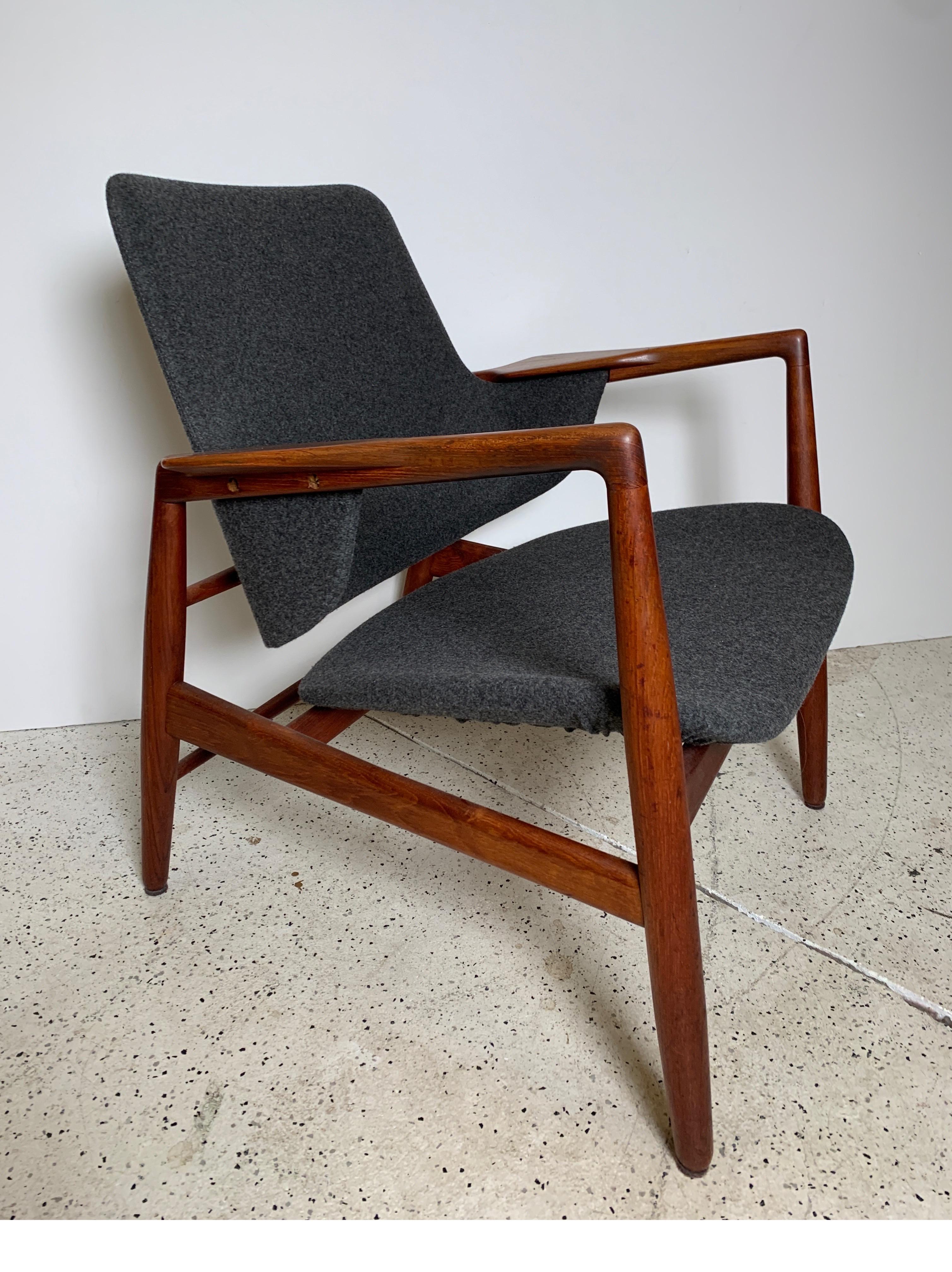 This scarce and beautiful chair, designed in 1953 by Ib Kofod Larsen, was executed by cabinetmaker Carlo Gahrn and retailed by Bovirke. The frame has been lightly restored, with attention paid to preserving patina and signs of age and use,