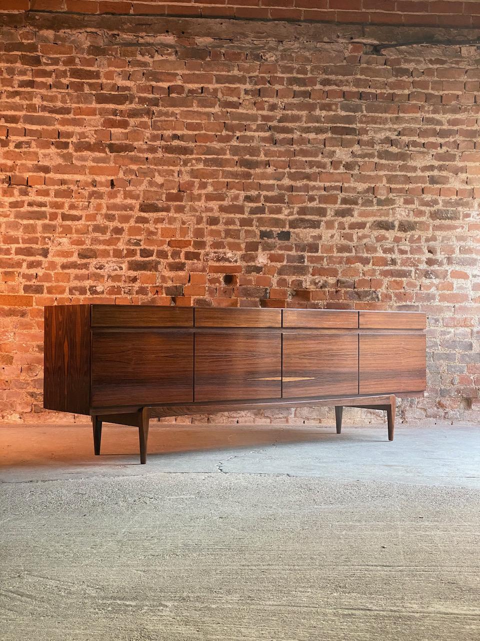 Ib Kofod-Larsen Model FA-66 rosewood sideboard by Faarup Møbelfabrik, 1960.

Mid-Century Modern Ib Kofod-Larsen for Faarup Møbelfabrik Model FA-66 Brazilian rosewood sideboard credenza, manufactured in Denmark circa1960, the rectangular top over