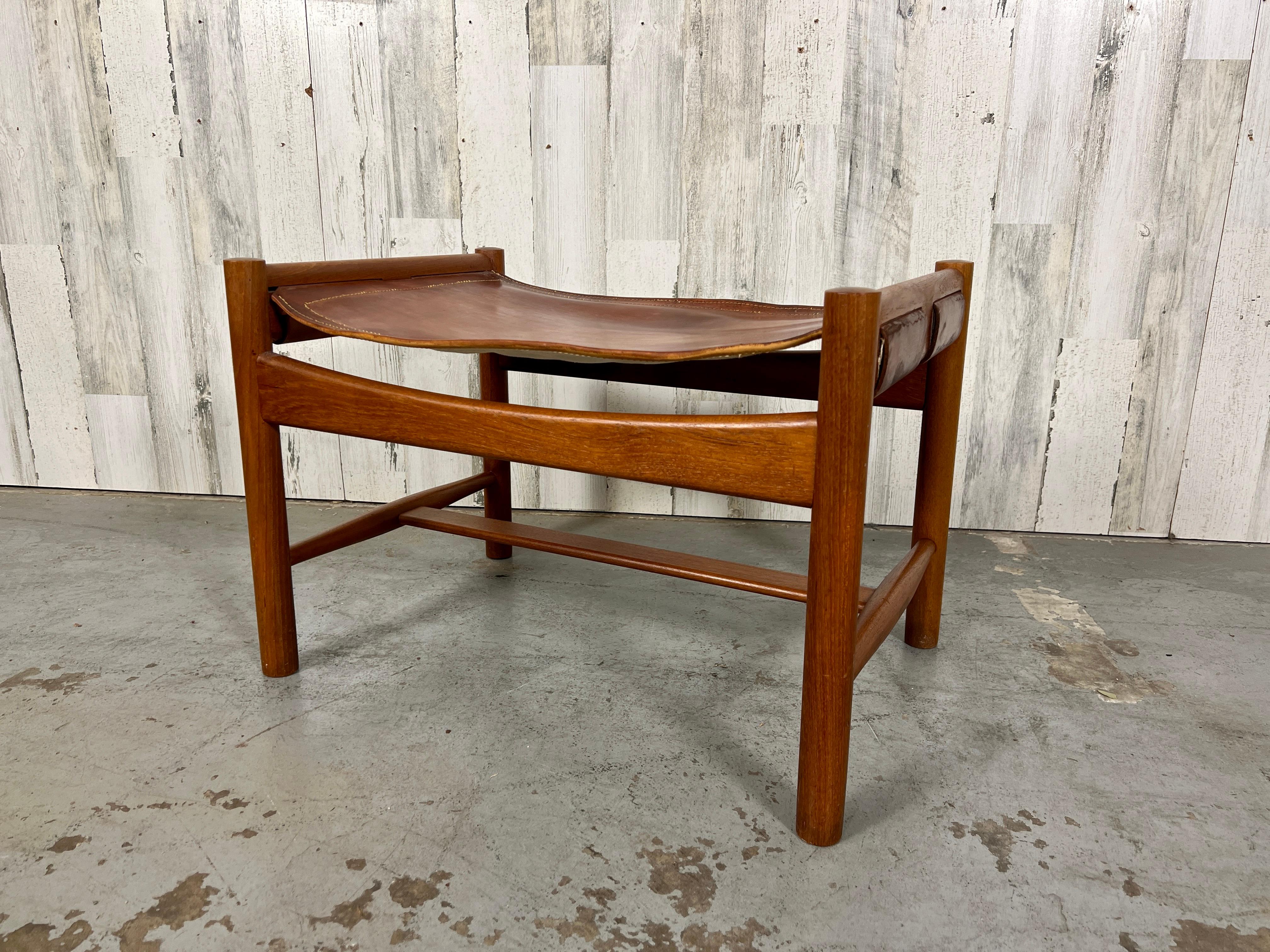 Rare Povl Dinesen Danish modern Teak ottoman with saddle leather sling. The leather has lots of patina with minor spotting. 