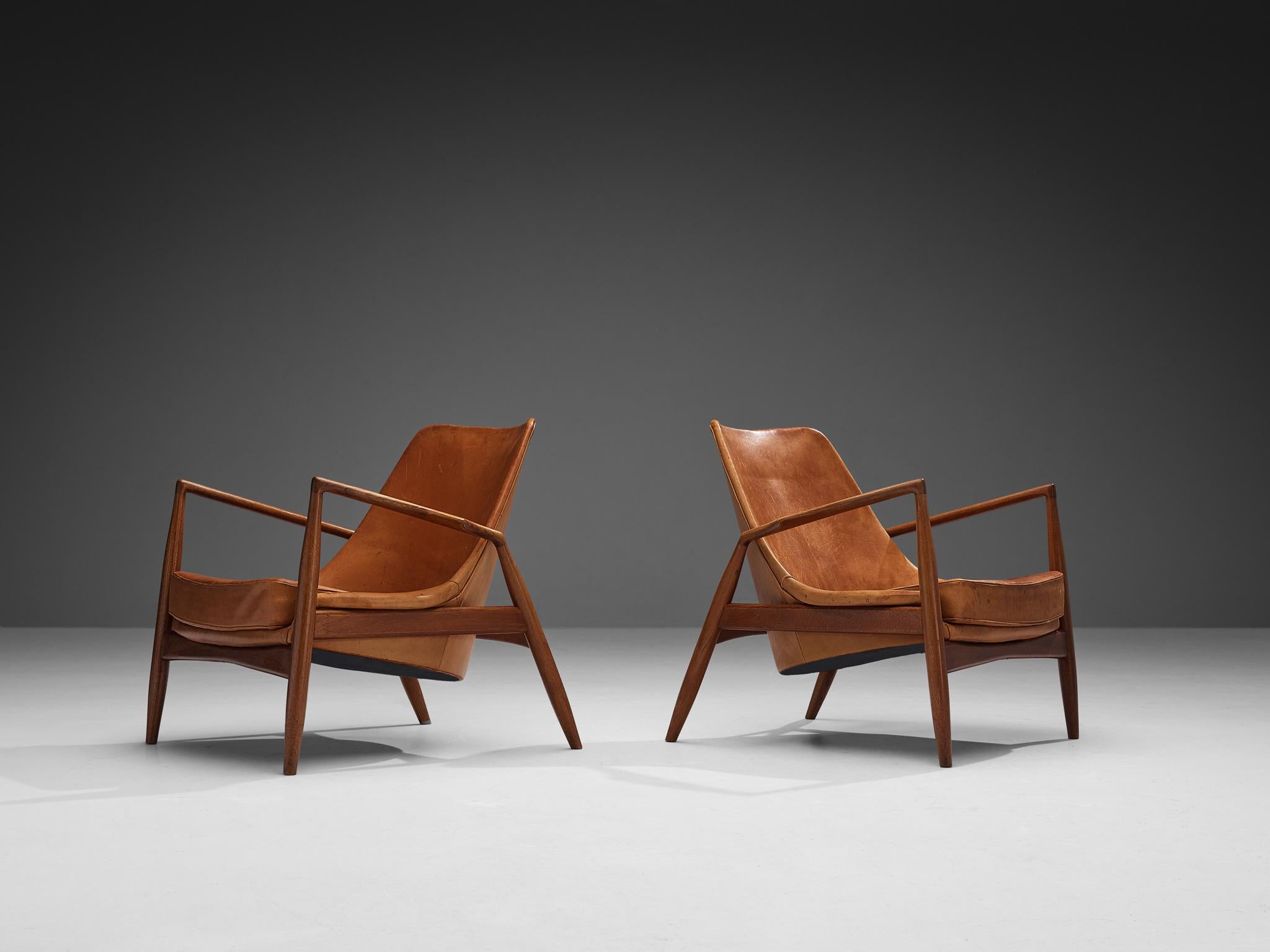 Swedish Ib Kofod-Larsen Pair of ‘Seal’ Lounge Chairs in Cognac Leather and Teak
