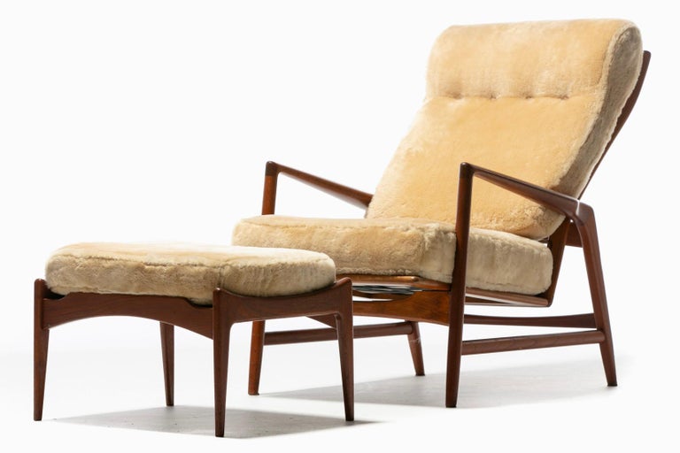 Beautiful reclining lounge chair and ottoman designed by Ib Kofod-Larsen for Selig freshly upholstered in hand sewn rich Oatmeal / Ivory Shearling. An early Mid Century Scandinavian Modern design hailing from 1950s Sweden, this Ib Kofod-Larsen chair