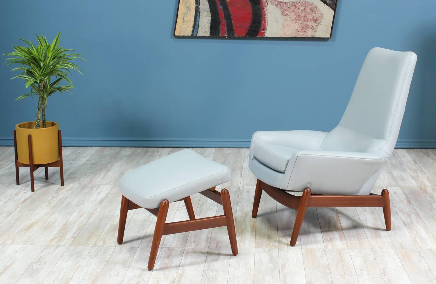 Lounge chair and Ottoman designed by Ib Kofod-Larsen for Povl Dinesen in Denmark circa 1950’s. Featuring an angled frame made of Afromosia teak wood that holds the recently upholstered seat in a beautiful light blue full grain leather. Both chair