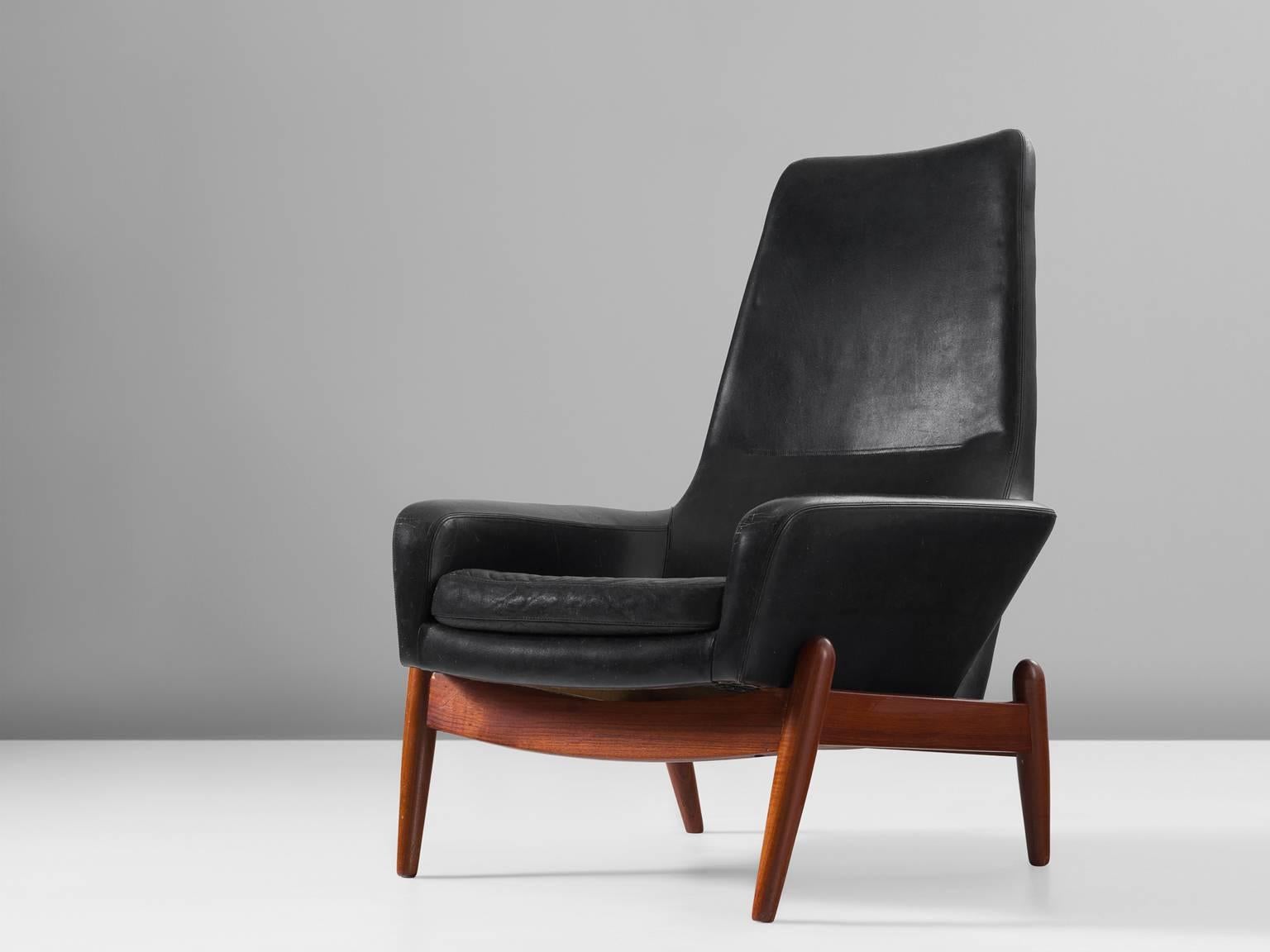 Ib Kofod-Larsen, PD30 chair in black leather and teak for Povl Dinesen, Denmark, 1960s.

The designer of this chair, Ib Kofod-Larsen (1921-2003) is known for his distinctive designs features and comfortable materials and simplistic lines, with