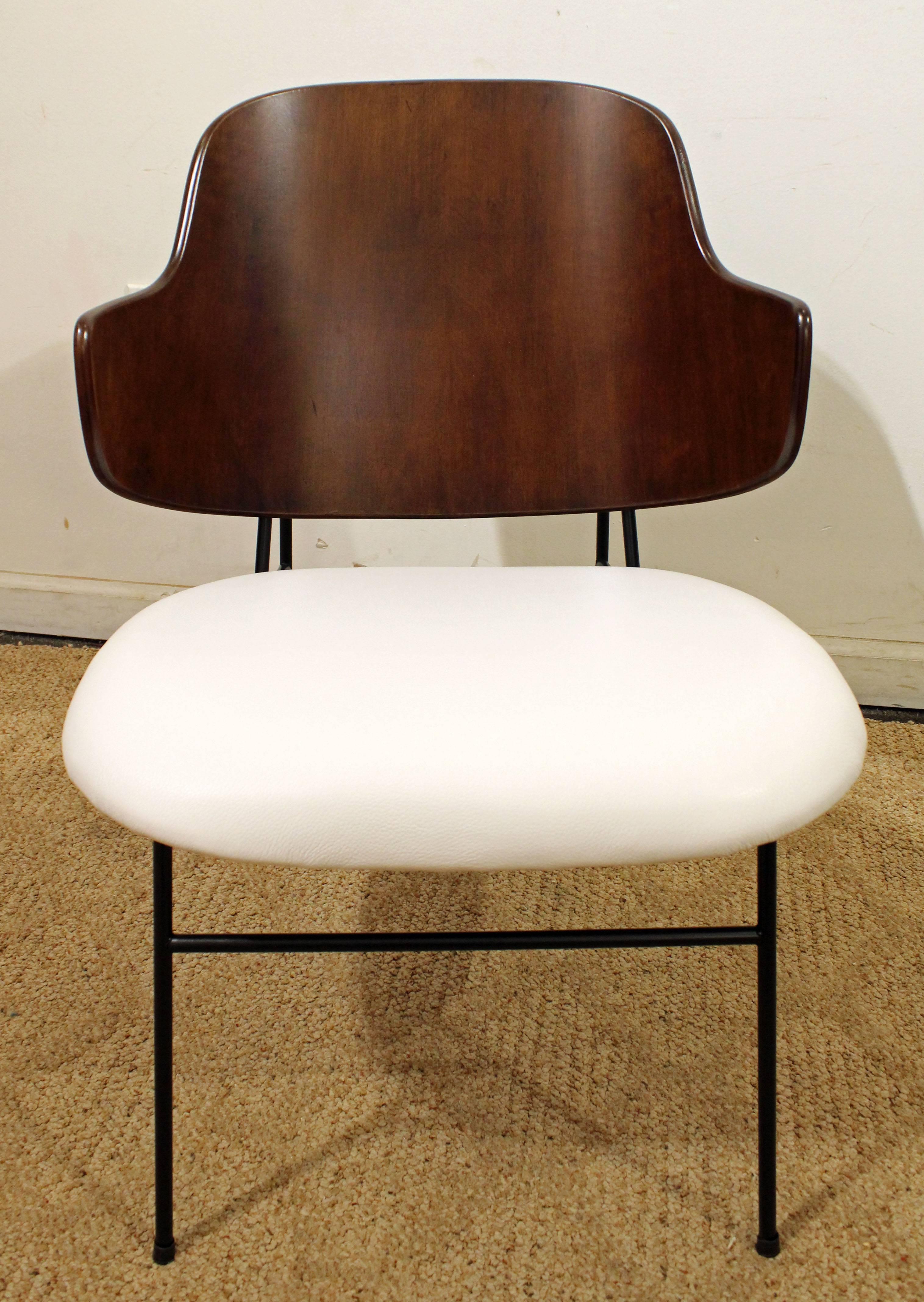 This is an original Penguin chair by IB Kofod Larsen. Has been completely restored with new leather and refinished walnut.
