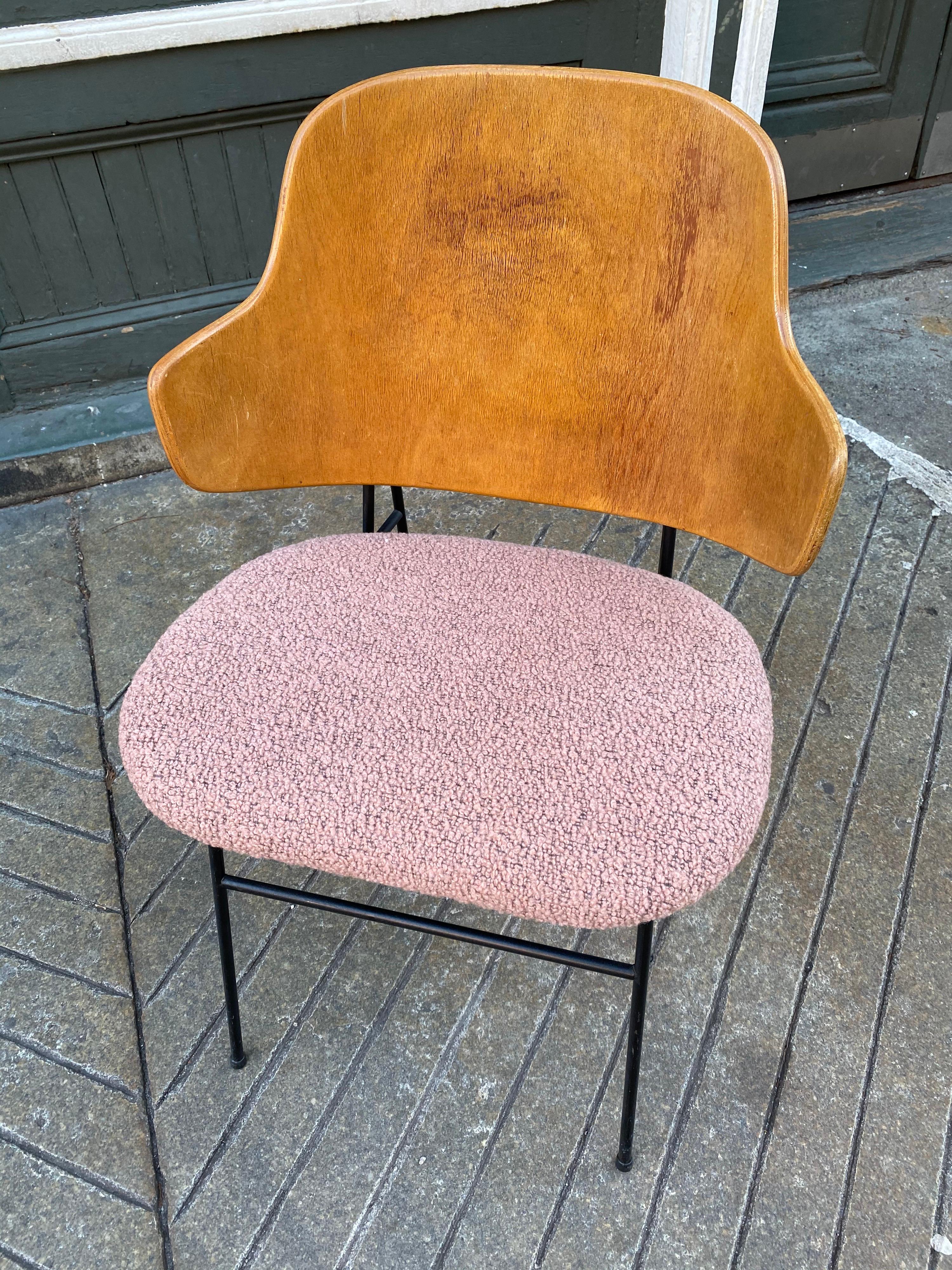 Ib Kofod-Larsen penguin chair with a newly upholstered vintage nubby salmon colored seat. Wood finish is original and shows a little finish loss, but still presents very well. Iron frame in good shape and retains all plastic feet. Stamped made in
