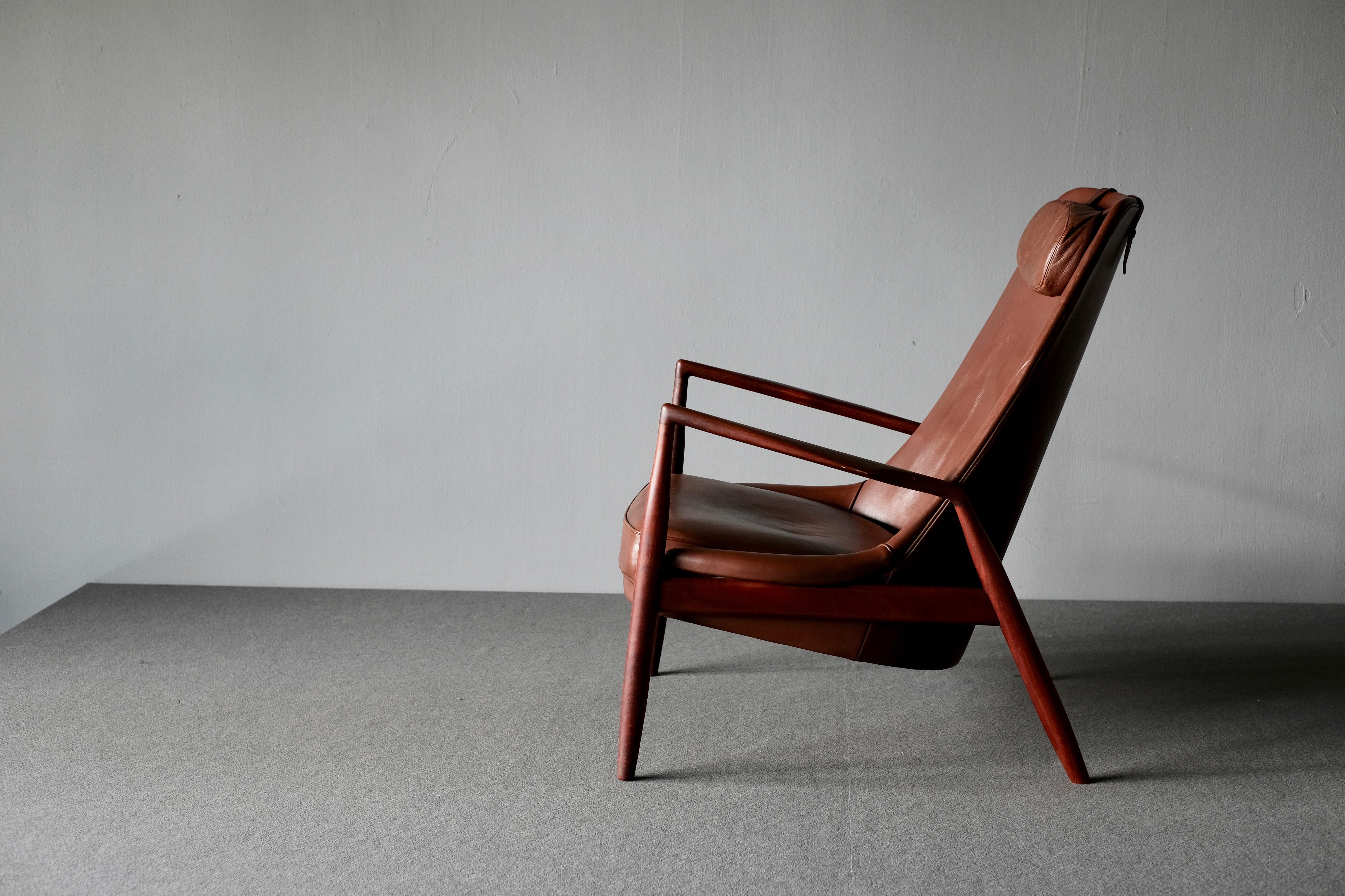 Rare and sought after high back lounge chair model 503-799 'Seal', in teak and leather by Ib Kofod-Larsen. Kofod-Larsen’s designs are appreciated by collectors the world over and are characterized by elegant lines and extraordinary craftsmanship.