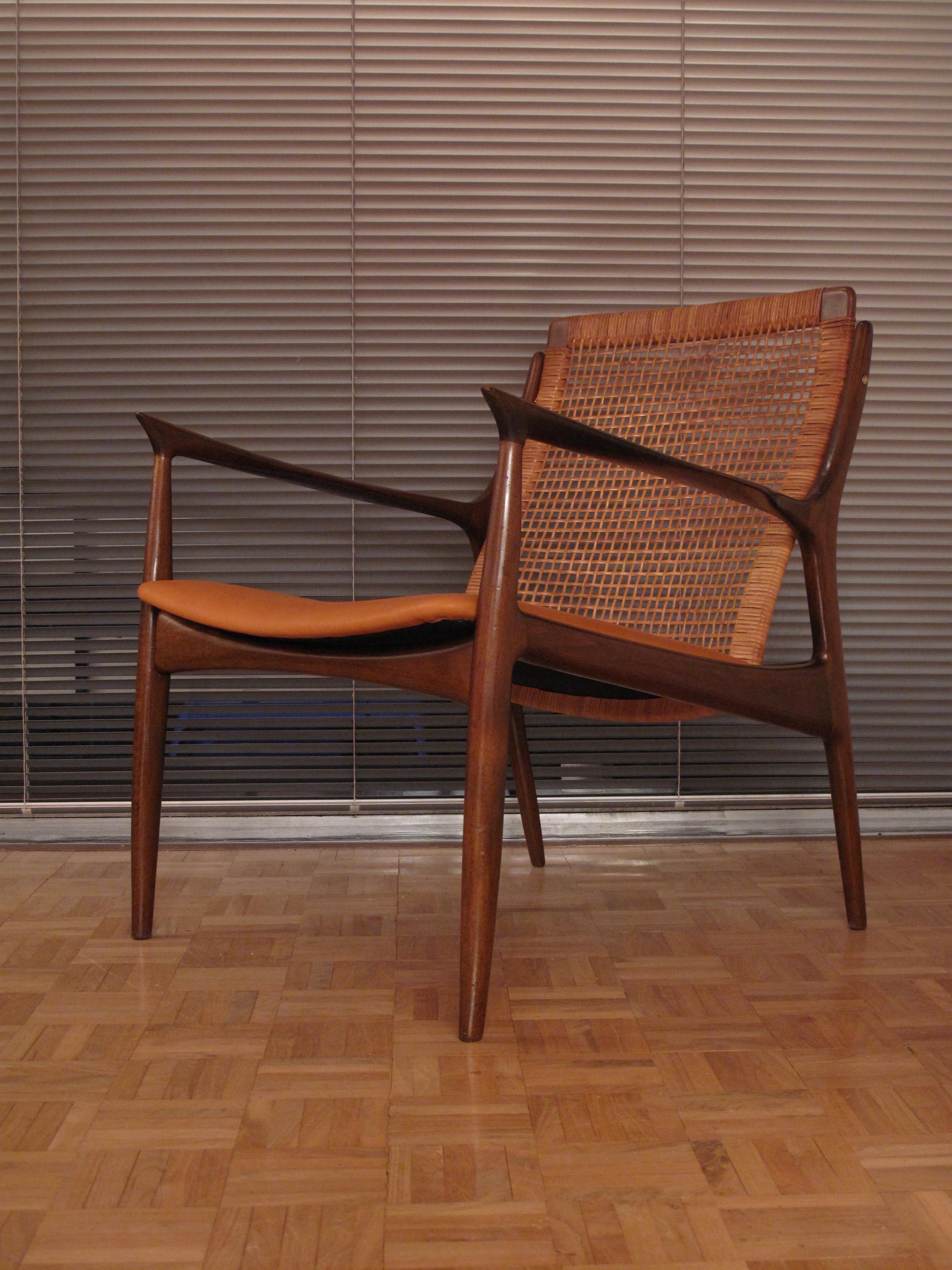 An incredibly handsome lounge chair designed by Ib Kofod Larsen for Selig.

Produced in Denmark the chair features its original dark stained beech finish and original rattan weave backrest. 

The seat has just been upholstered in the finest