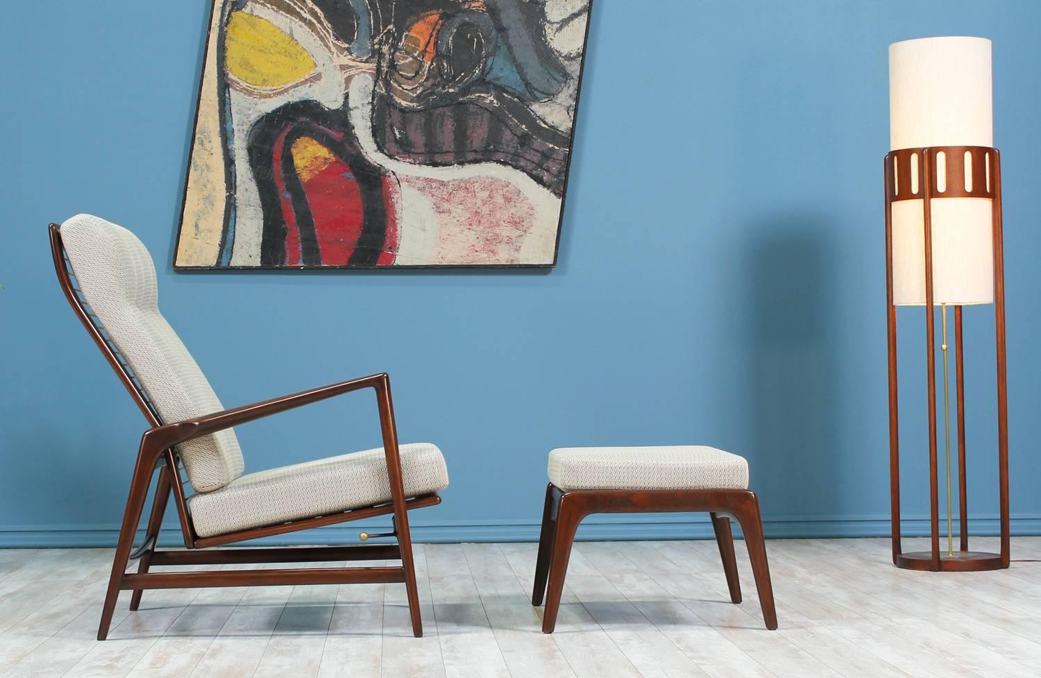 Reclining Lounge Chair with ottoman designed by Ib Kofod-Larsen for Selig in Denmark circa 1960’s. This attractive newly restored Danish Modern design features a walnut-stained beech wood frame with sculpted and angled armrests. With a sculpted