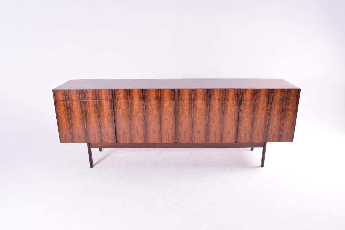 Rosewood sideboard design by master craftsman Ib Kofod Larsen, for Faarup Møbelfabrik, similar to other Kofod Larsen designs this model has four drawers and four doors, with an exquisite rosewood coincident veneer. Fully restored and in excellent