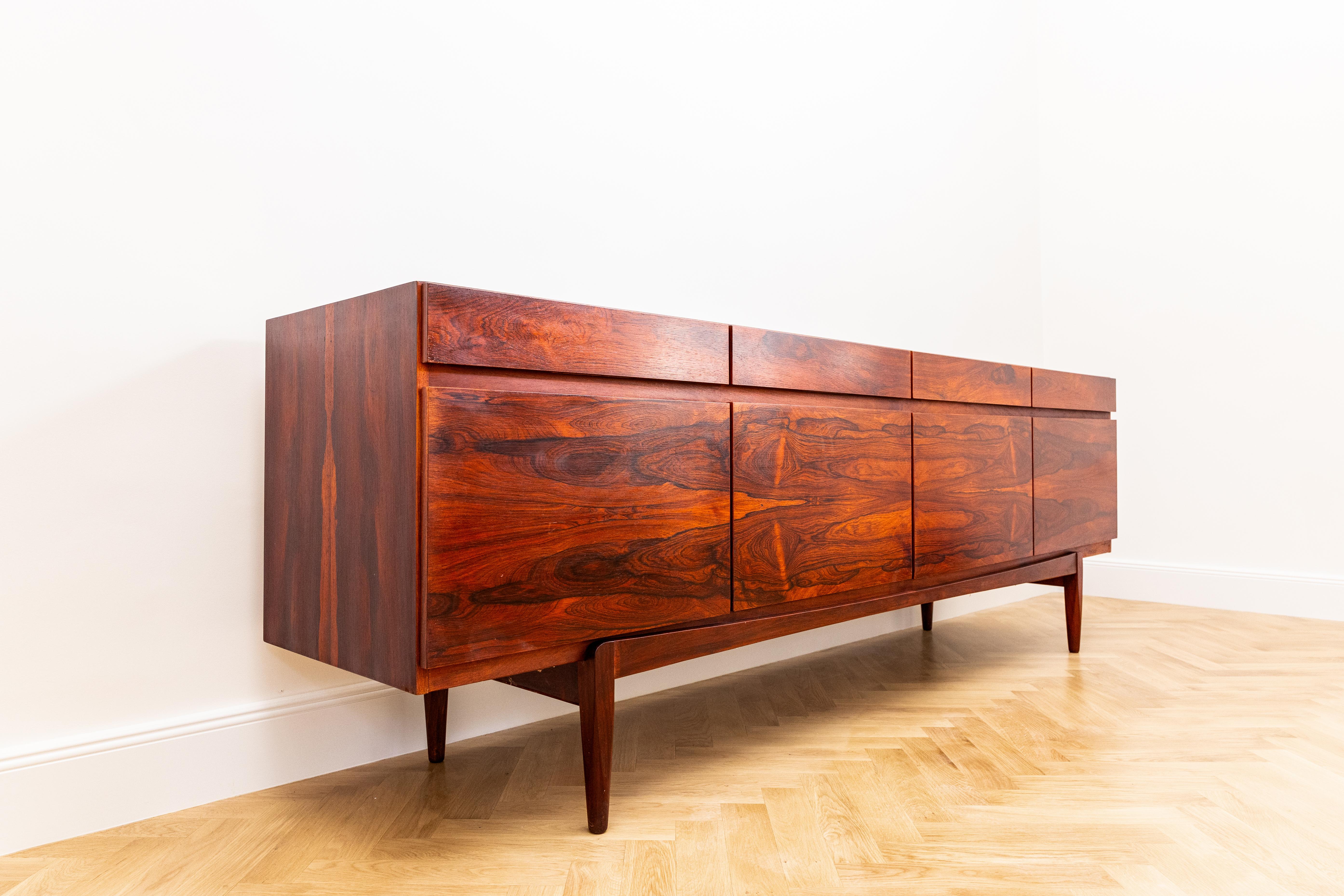 This rare early Model FA-66 sideboard by Ib Kofod-Larsen for Faarup Møbelfabrik, crafted in Denmark in the 1960s, is a collector-grade example of Scandinavian Modern design, celebrated for its architectural balance and refined proportions.

The