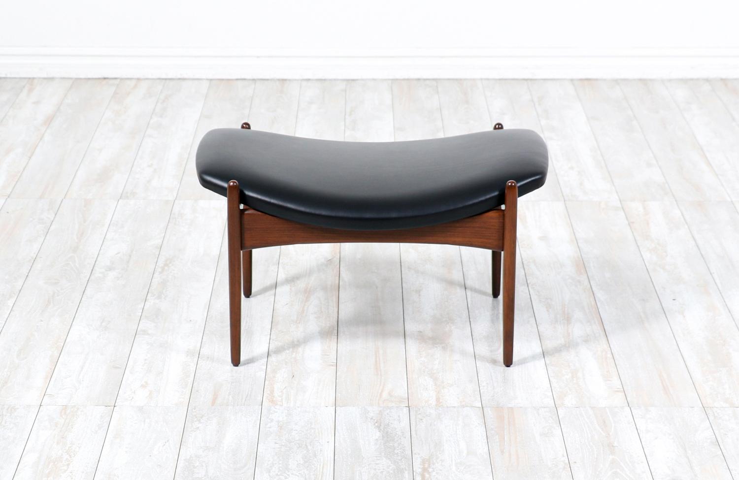 Stylish sculptural stool designed by Ib Kofod-Larsen, in collaboration with the Danish / American company Selig, int the 1960s. This beautifully designed modern stool features a sculpted wood frame that supports its comfortable new high-density foam