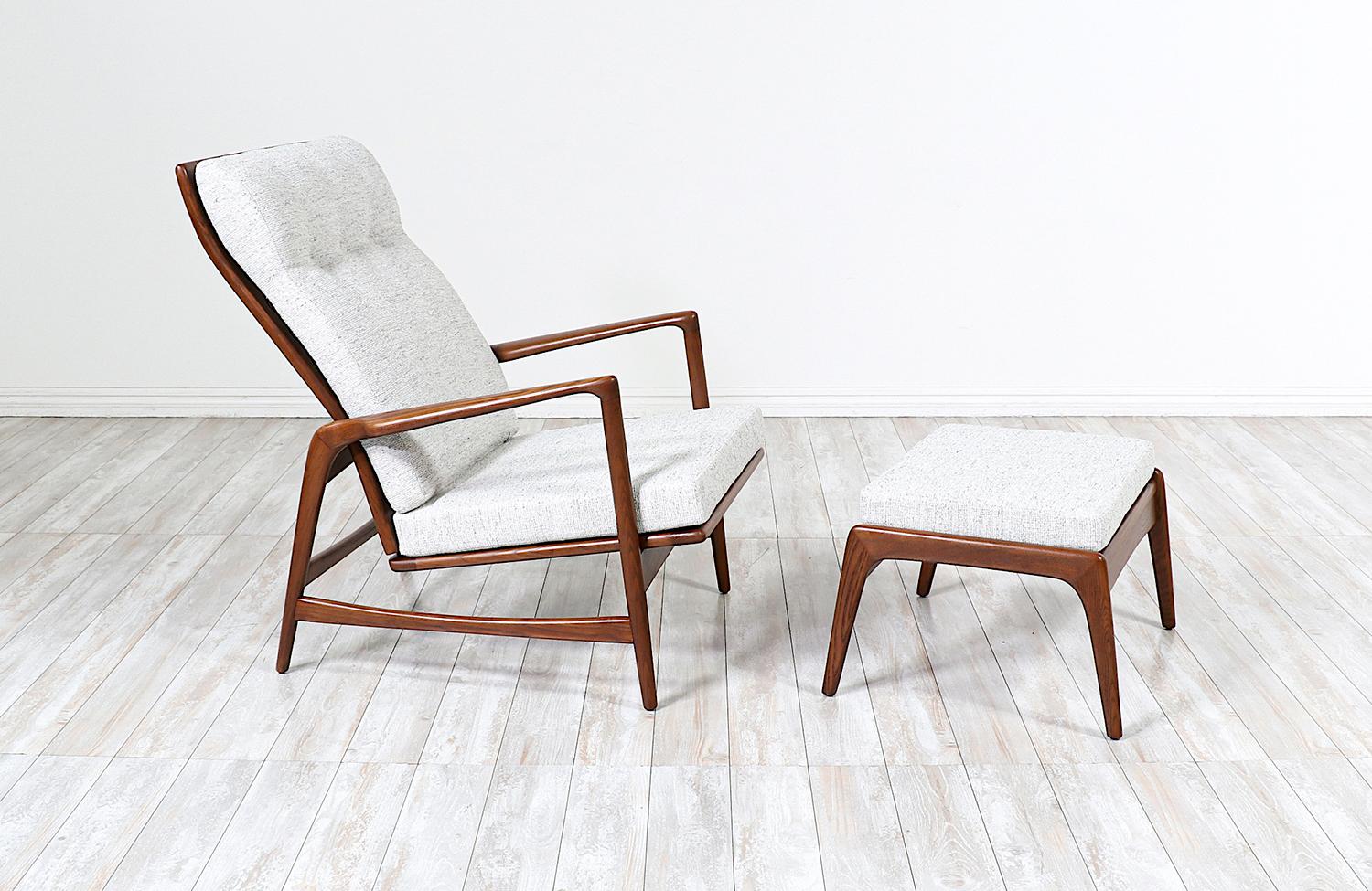 Reclining Lounge Chair with ottoman designed by Ib Kofod-Larsen for Selig in Denmark circa 1950’s. This attractive newly restored Danish Modern design features a walnut-stained oak wood frame with sculpted and angled armrests. With a sculpted back,