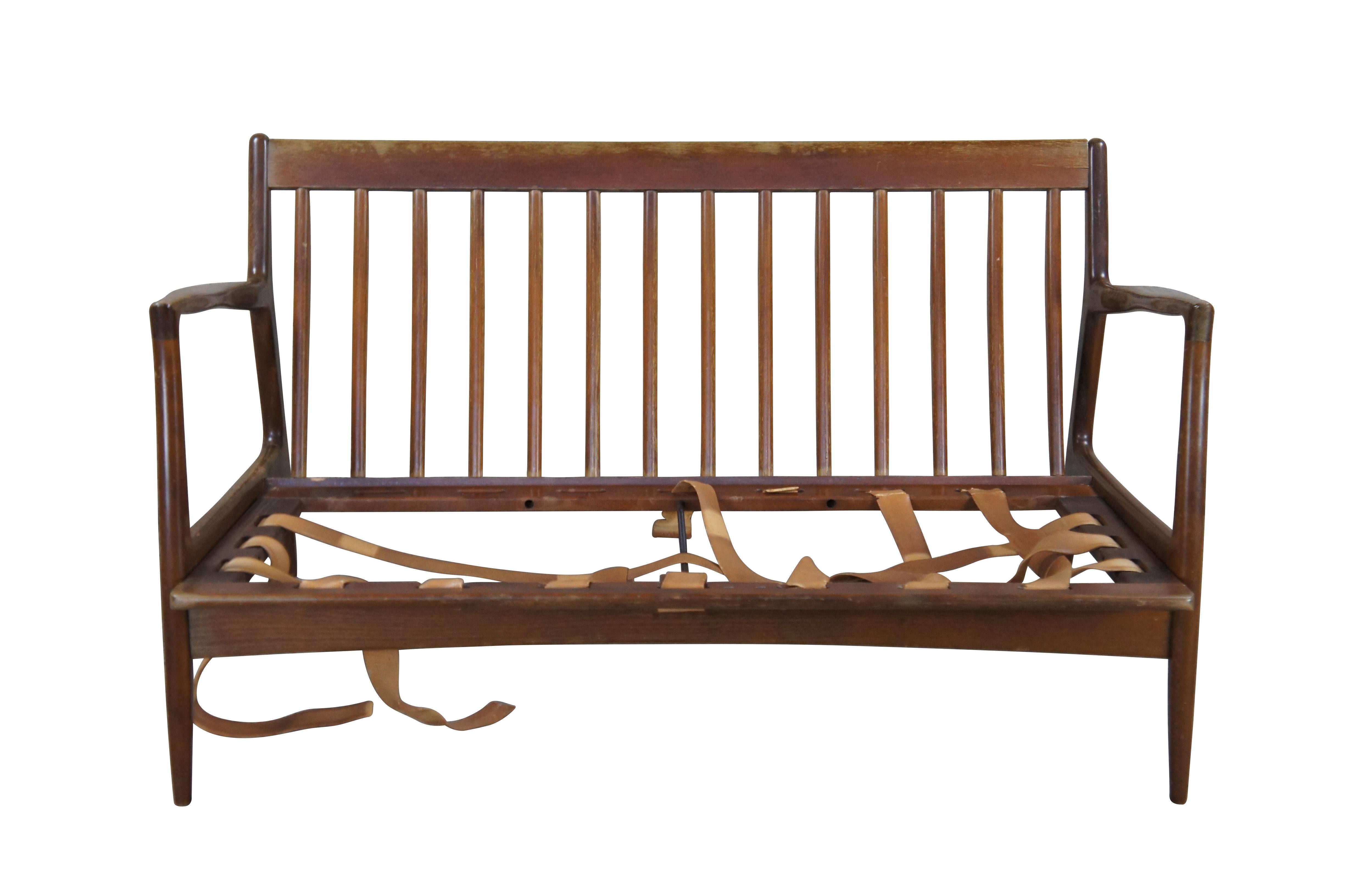 Mid century modern IB Kofod Larsen for Selig Danish / Scandinavian settee / love seat or sofa.  Made of walnut featuring sculpted frame with high sloped arms, tapered legs and vertical slats.

Ib Kofod-Larsen, born in 1921 in Denmark, studied at the