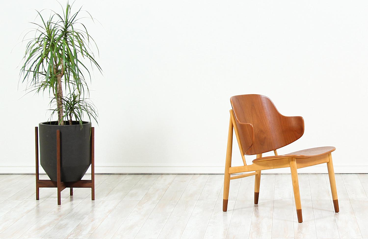 Beautiful modern shell chairs, crafted by Danish architect and furniture designer Ib-Kofod Larsen, and manufactured by Christensen & Larsen A/S in Denmark, circa 1950s. This spectacular design features a sturdy beech wood frame with mounted teak