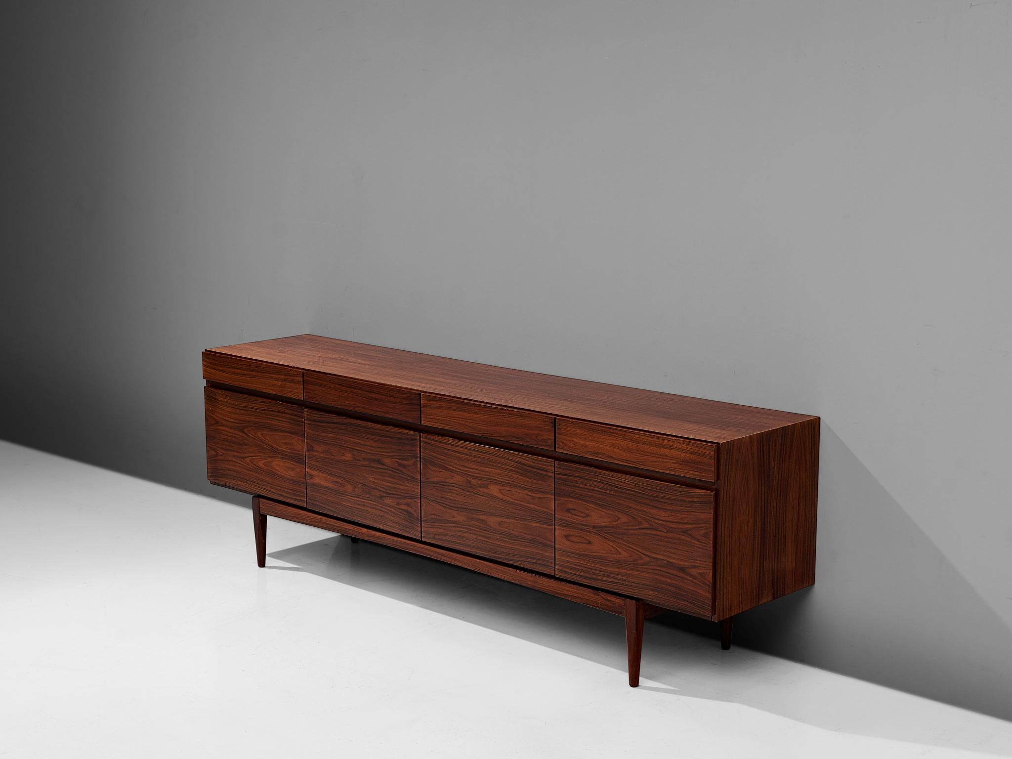 Ib Kofod-Larsen for Faarup Møbelfabrik, sideboard model FA66, rosewood, Denmark, 1960s.

Excellent designed credenza by Ib Kofod-Larsen. The sideboard contains four doors with four drawers directly above it. The inside contains three shelves and