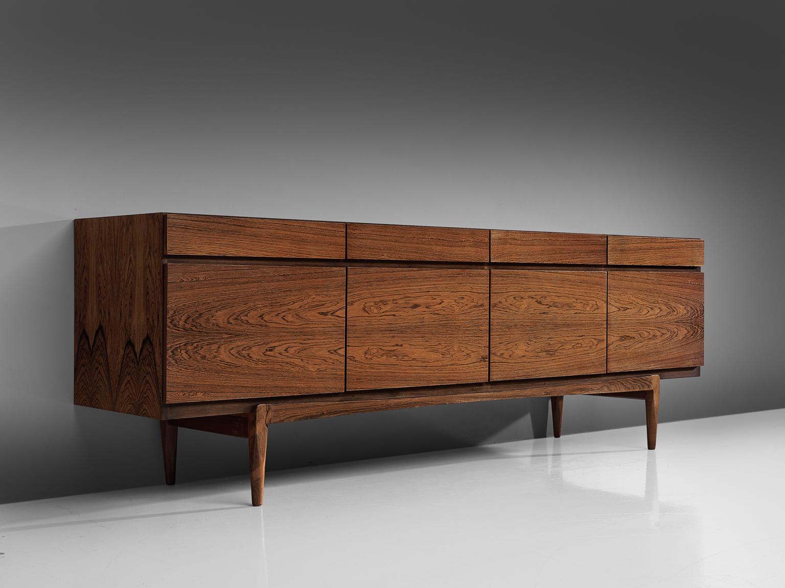 Ib Kofod-Larsen for Faarup Møbelfabrik, sideboard model FA66, rosewood, Denmark, 1960s.

Excellent designed credenza by Ib Kofod-Larsen. The sideboard contains four doors with four drawers directly above it. The inside contains three shelves and