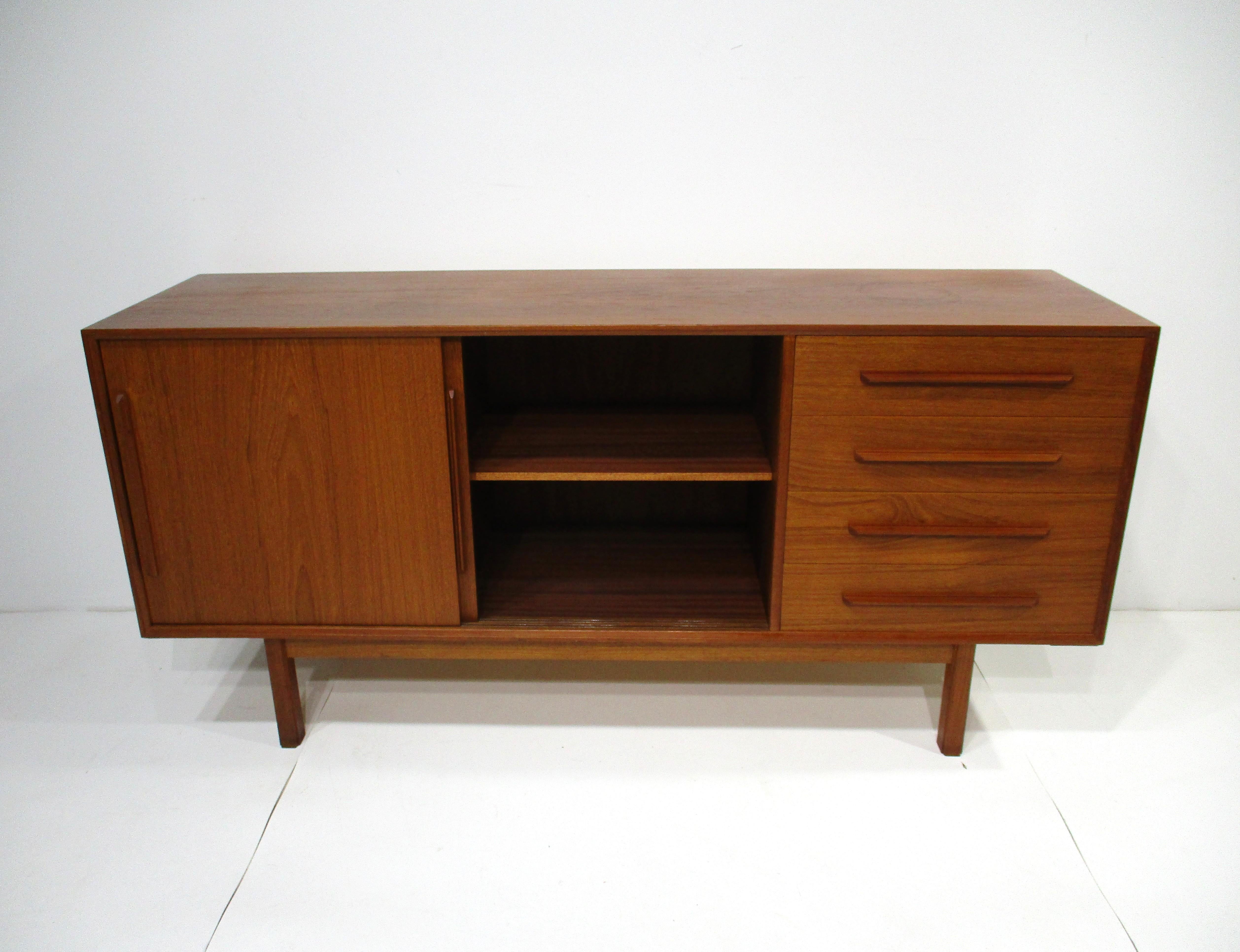 A very well-crafted teak wood credenza or sideboard with double sliding door with adjustable shelves and four drawers. This piece not too big and not too small is perfect for that living room, dining room or for your entertainment systems. Designed